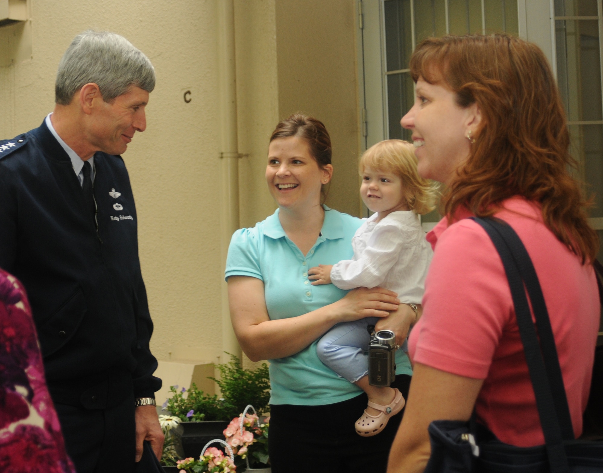 YOKOTA AIR BASE, Japan -- Chief of Staff of the Air Force Gen. Norton Schwartz, visits with Amanda Miner, daughter Sophie, and family friend Jennifer Cox, May 12 during a visit to the base's East Side housing complex.  Base civil engineers gave the general a tour of a renovated garden house and the East Side Steam Plant during his first visit here since he became chief of staff Aug. 12, 2008. (U.S. Air Force photo/Airman Sean Martin)