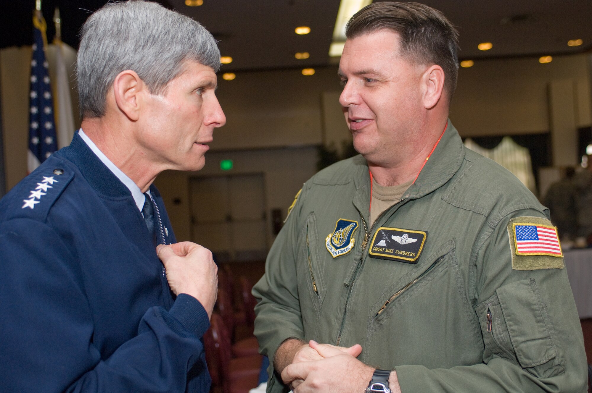 YOKOTA AIR BASE, Japan -- General Norton Schwartz, Air Force chief of staff, talks with Chief Master Sgt. Michael Sundberg, 36th Airlift Squadron, May 12 about the aging C-130 Hercules fleet following a breakfast at the Yokota Officers' Club. When Chief Sundberg, who will retire this summer after 30 years of service, entered the Air Force in 1979 the 374th Airlift Wing's fleet of C-130s were already five years old. (U.S. Air Force photo/Osakabe Yasuo)