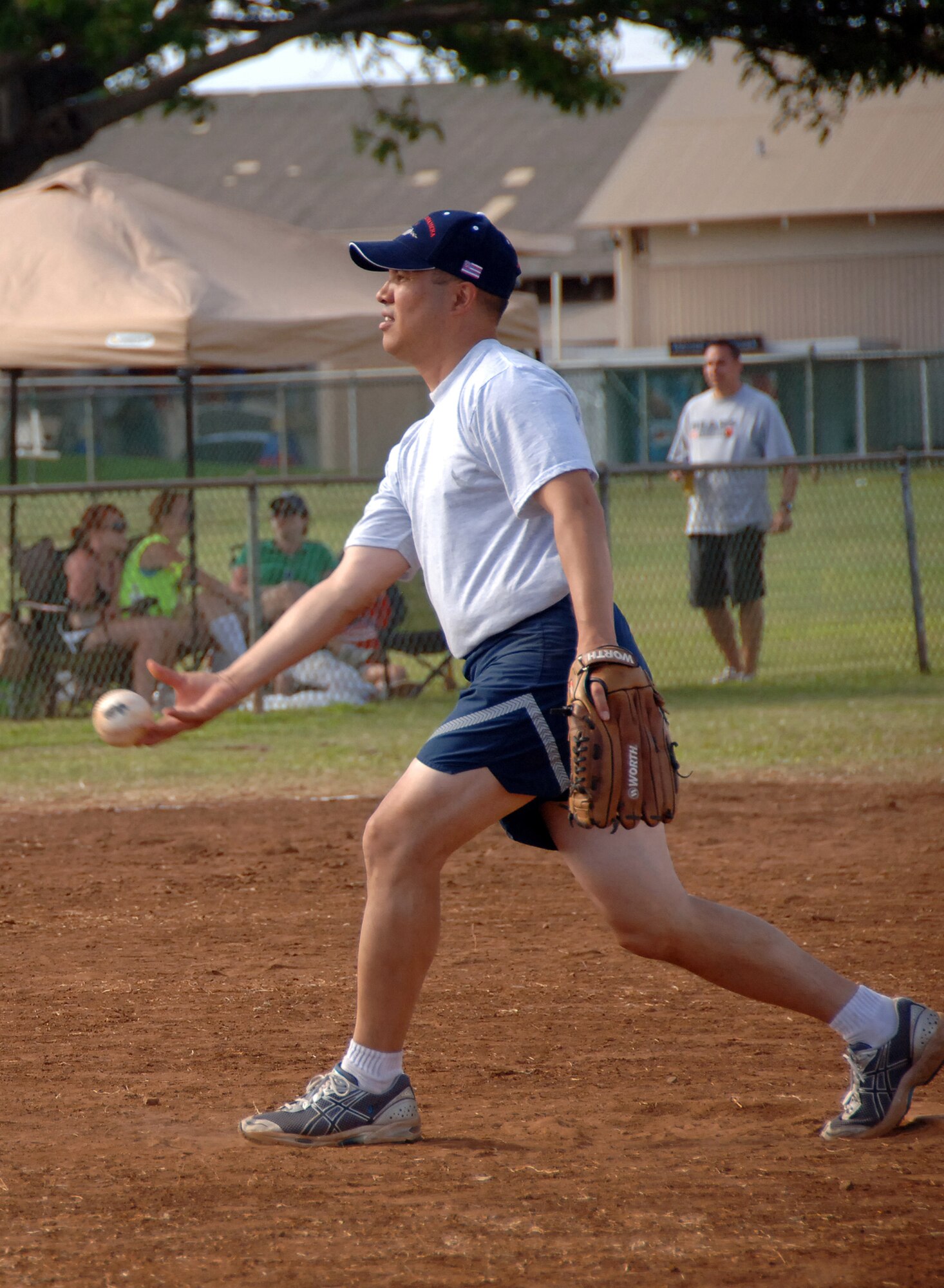 HICKAM AIR FORCE BASE, Hawaii -- Col. Giovanni Tuck, 15th Airlift Wing commander, serves up a fastball during the Chiefs vs. Eagles softball game. (U.S. Air Force photo by CIV Vanessa M. Perez)