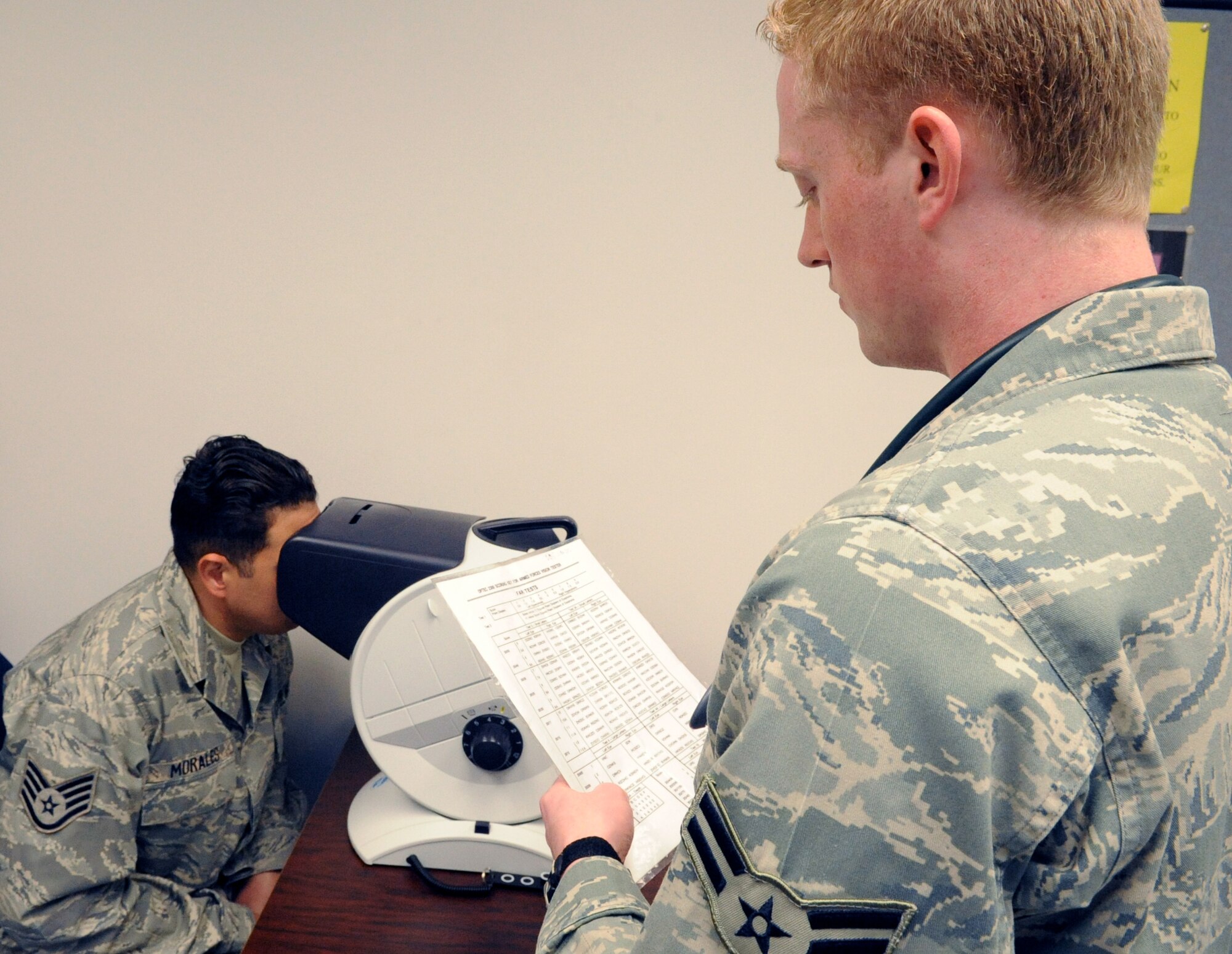 With help from Clinical Medical Technician Airman 1st Class Nicholas Sparks, of the 87th Medical Group's Primary Care section, Staff Sergeant Freddie Morales-Fernandez, of the 87th Civil Engineering Squadron, undergoes the eye exam portion of his Preventive Health Assessment on May 7. The Preventive Health Assessment cell provides one-stop service for all its customers, whether Air Force, Army, Coast Guard or Navy. (U.S. Air Force photo/Wayne Russell)