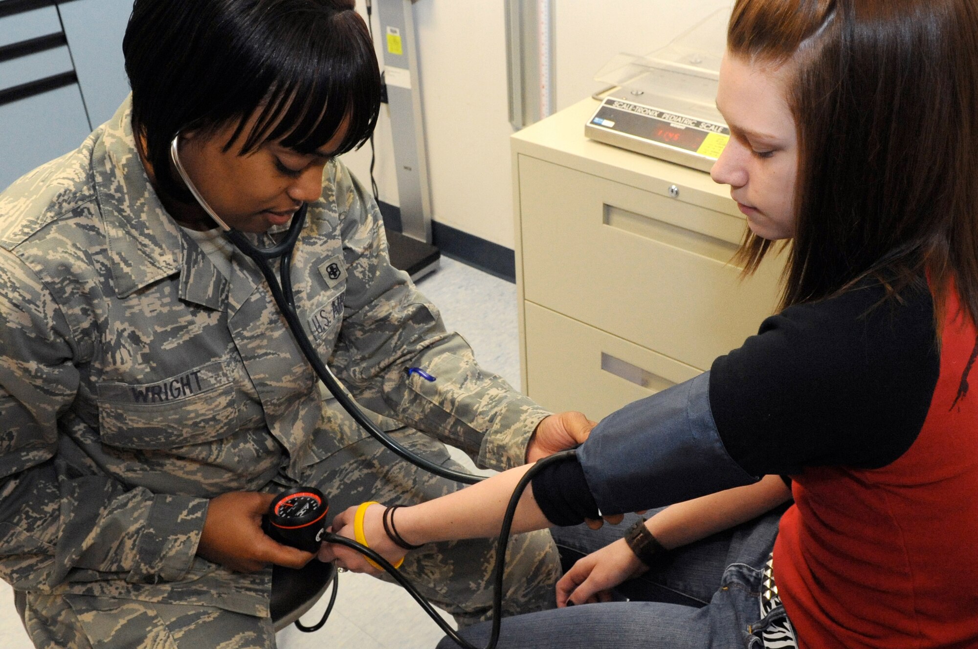 Senior Airman Melissa Wright, a medical technician from the 87th Medical Group's  Pediatrics unit, takes the vital signs of Rachel Neitzke, daughter of Lt. Col. William Neitzke, of the 621st Combat Response Wing. Beyond their responsibilities of taking  a patient's blood pressure, temperature weight and height, medical technicians provide medical care to U.S. forces and local nationals via deployments to Iraq and Afghanistan. (U.S. Air Force photo/Wayne Russell)