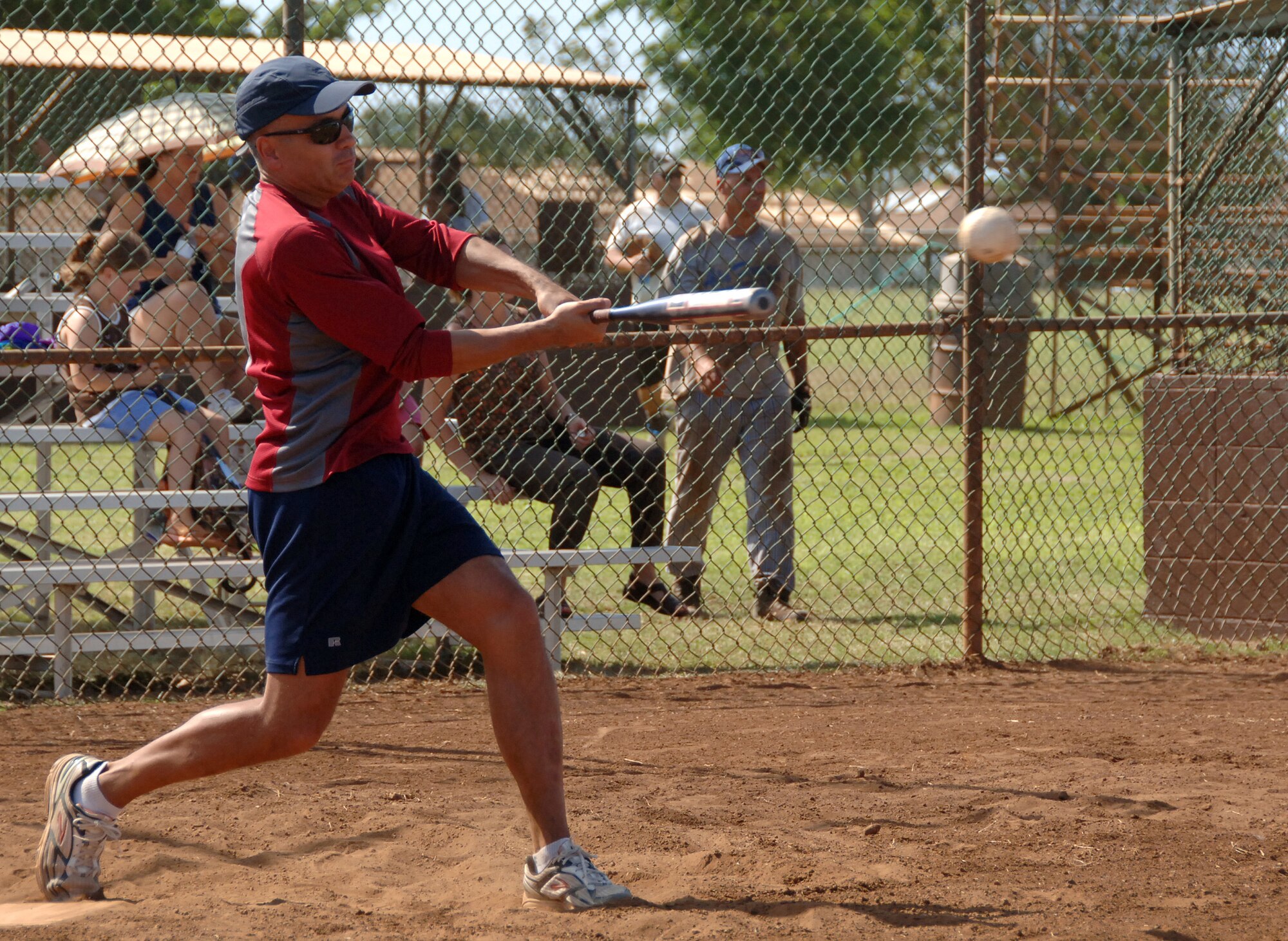 HICKAM AIR FORCE BASE, Hawaii -- Lt. Col. Robert Howe, 15th Operations Group deputy commander, swings for a homerun during the Chiefs vs. Eagles softball game. at the Hickam Sports Day event held May 8. The chiefs won 8-1. The day's events, which were to built comeraderie and fitness, also included one-pitch softball, three-on-three basketball, bowling/par three golf biathlon, dodge ball, four-on-four flag football, ultimate Frisbee, a fitness challenge, kick-ball, free food, and an award ceremony. (U.S. Air Force photo/Vanessa M. Perez)