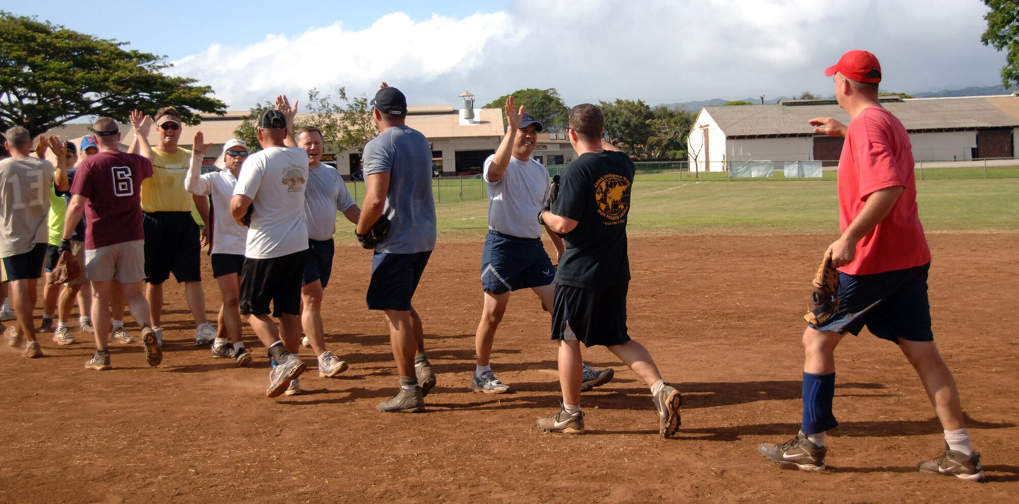 HICKAM AIR FORCE BASE, Hawaii -- Commanders and chiefs of the 15th Airlift Wing high-five one another in good sportsmanship after the Chiefs vs. Eagles softball game. (U.S. Air Force photo/Vanessa M. Perez)
