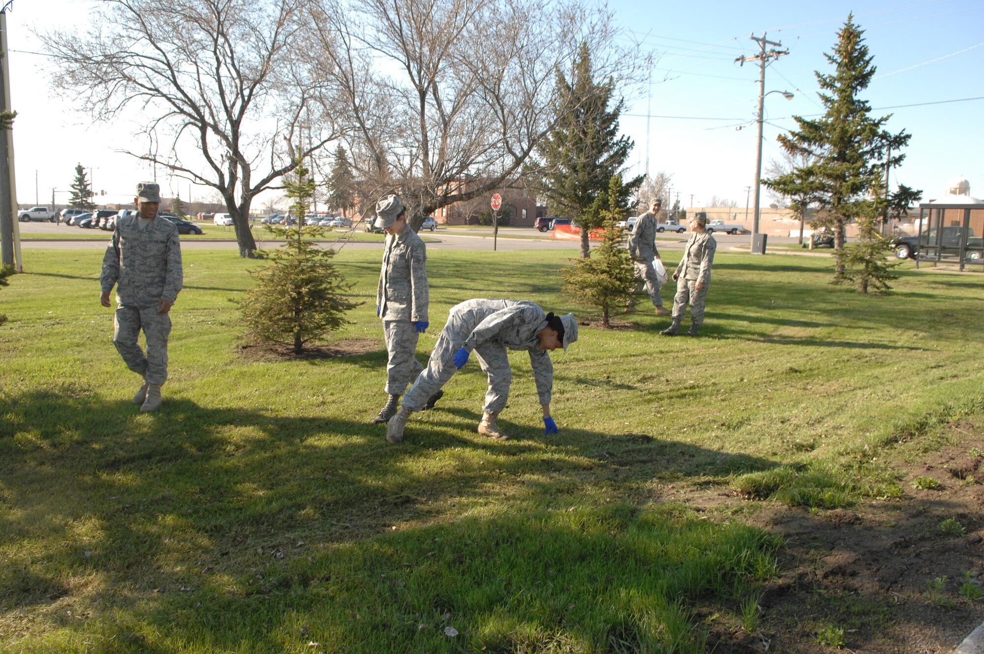 MINOT AIR FORCE BASE, N.D. -- Members from the 5th Mission Support Group collect trash and debris during a base-wide cleanup here May 11. Airmen from both the 5th Bomb Wing and the 91st Missile Wing joined together to beautify the base after one of harshest winters in 12 years. (U.S. Air Force photo by Staff Sgt. Angel Gallardo)