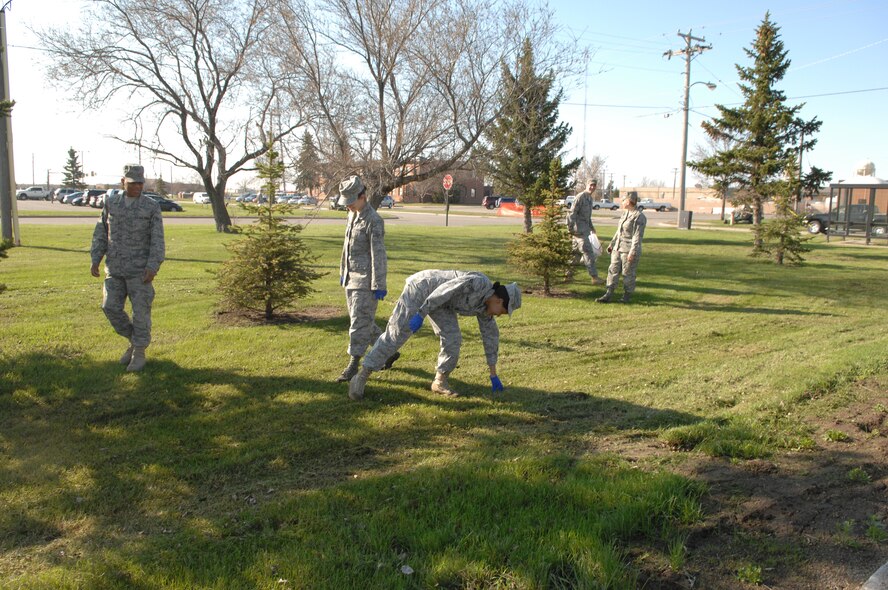 MINOT AIR FORCE BASE, N.D. -- Members from the 5th Mission Support Group collect trash and debris during a base-wide cleanup here May 11. Airmen from both the 5th Bomb Wing and the 91st Missile Wing joined together to beautify the base after one of harshest winters in 12 years. (U.S. Air Force photo by Staff Sgt. Angel Gallardo)