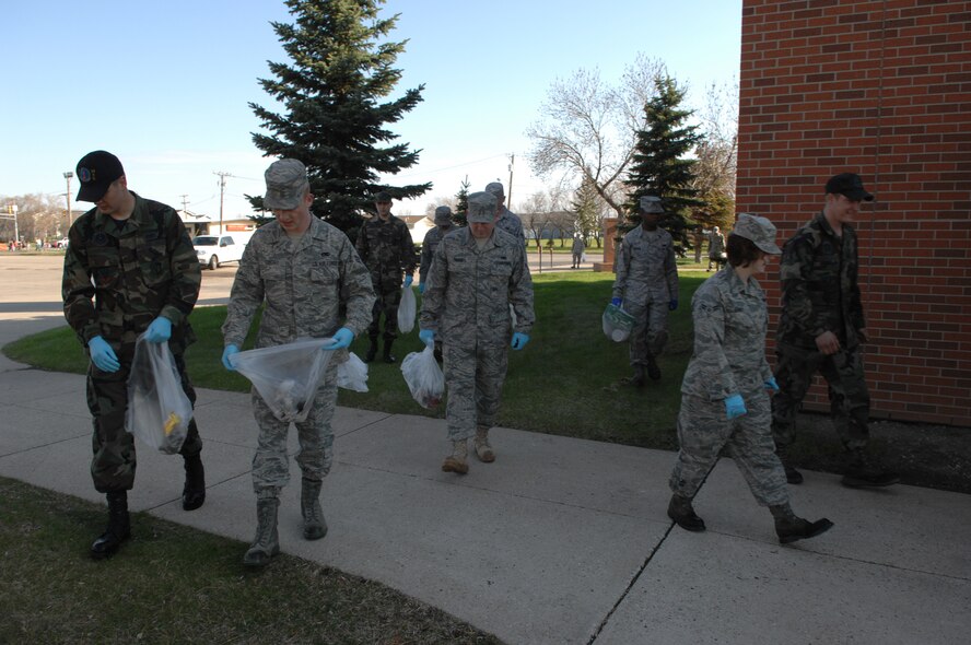 MINOT AIR FORCE BASE, N.D. -- Members from the 5th Maintenance Squadron collect trash and debris during a base-wide cleanup here May 11. Airmen from both the 5th Bomb Wing and the 91st Missile Wing joined together to beautify the base after one of harshest winters in 12 years. (U.S. Air Force photo by Staff Sgt. Angel Gallardo)