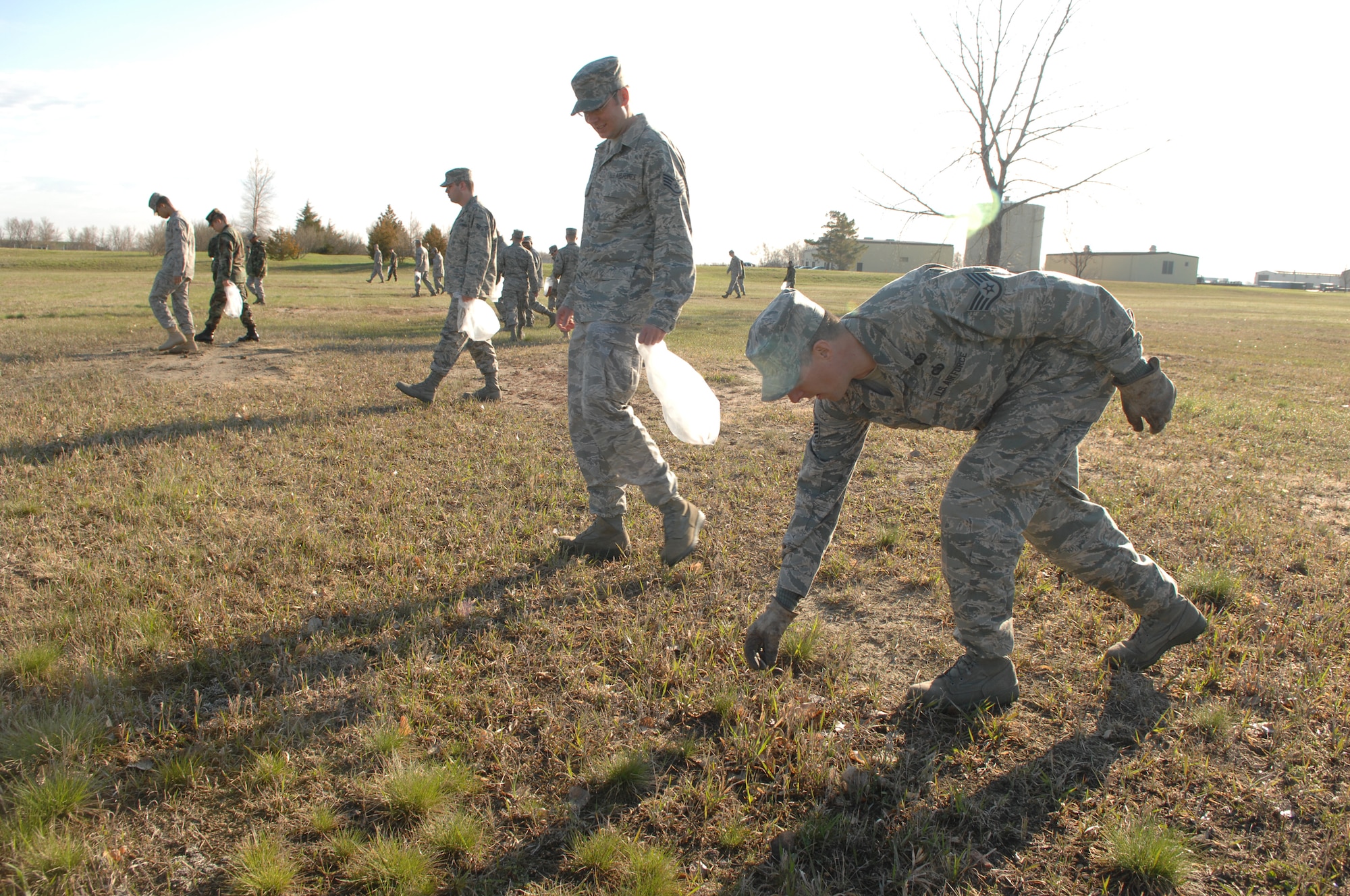 MINOT AIR FORCE BASE, N.D -- Members from the 5th Bomb Wing collect trash and debris during a base-wide cleanup here May 11. Airmen from both the 5th BW and the 91st Missile Wing joined together to beautify the base after one of the harshest winters in 12 years. (U.S. Air Force photo by Staff Sgt. Angel Gallardo)