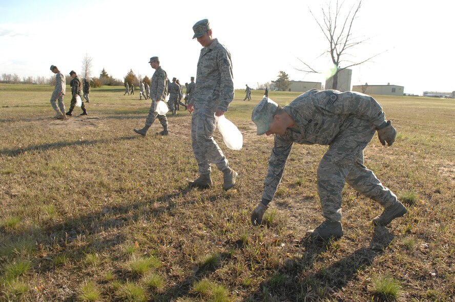 MINOT AIR FORCE BASE, N.D -- Members from the 5th Bomb Wing collect trash and debris during a base-wide cleanup here May 11. Airmen from both the 5th BW and the 91st Missile Wing joined together to beautify the base after one of the harshest winters in 12 years. (U.S. Air Force photo by Staff Sgt. Angel Gallardo)