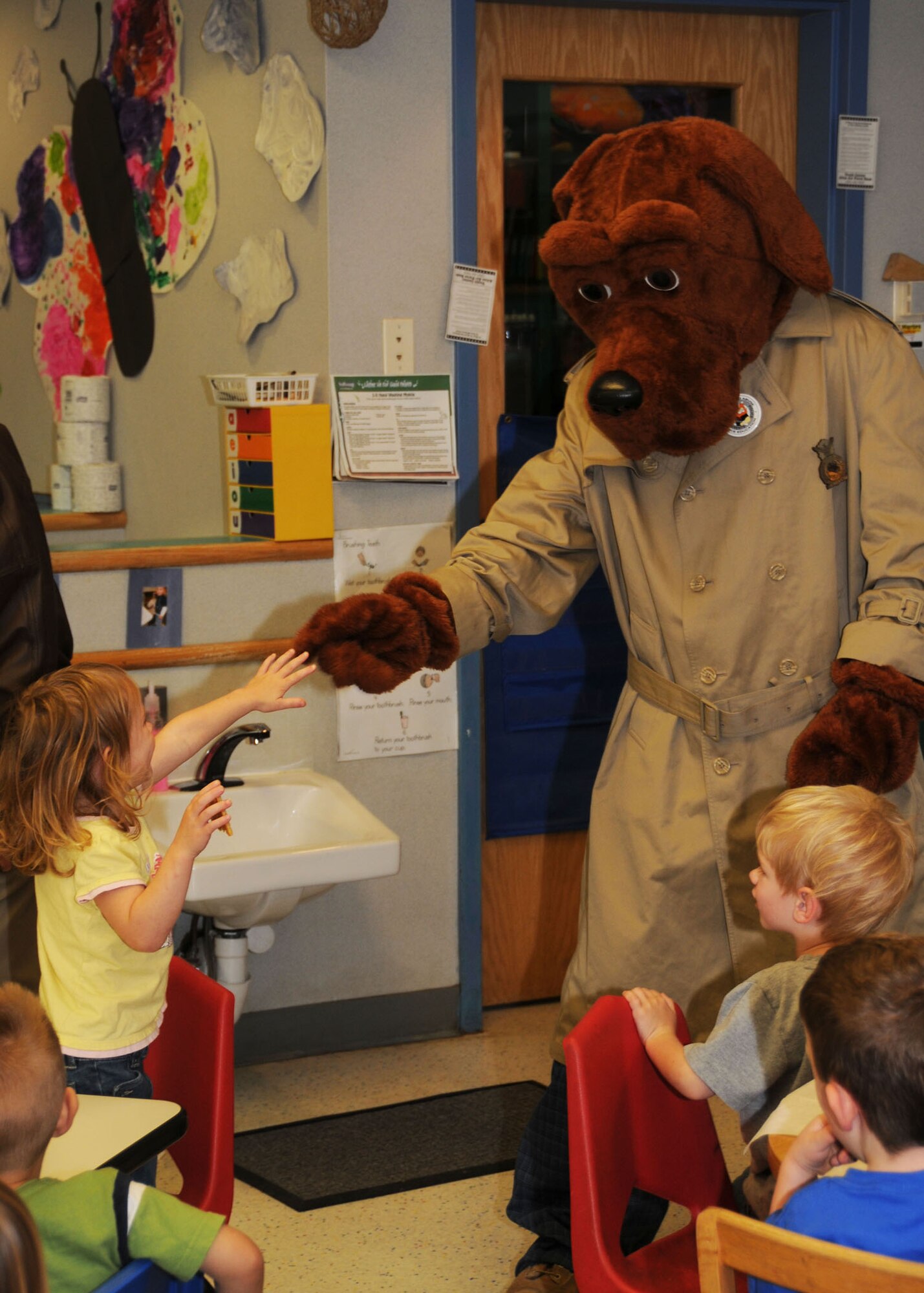 ALTUS AIR FORCE BASE, Okla. -- Scruff McGruff, the crime dog, visits children at the Child Development Center May 11. Scruff McGruff and his partner educated the children on the dangers of committing crimes and talking to strangers. (U.S. Air Force photo/Airman 1st Class Tiffany M. Deuel)