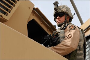 CAMP STRYKER, Iraq – Staff Sgt. Shawn Hardesty, 732nd Expeditionary Security Forces Squadron Detachment 2, oversees the other security forces Airmen gearing up for their mission, Camp Stryker, Iraq, May 8.  The Airmen will convoy outside the wire to a local city to train and mentor the Iraqi police on everything from conducting basic patrols to weapon handling techniques. Sergeant Hardesty, who is deployed from Langley Air Force Base, Va., is a native of Terra Alta, W.V.  (U.S. Air Force photo/Senior Airman Jacqueline Romero)      