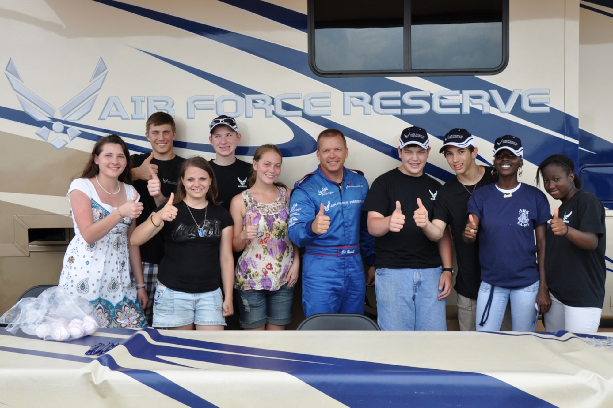 Benton, Airline and College Loyal Prep High School students who volunteered for the day to help 917th Wing recruiters from Barksdale Air Force Base, La., take a moment during the Defenders of Liberty Air Show 2009, to strike a pose for the cameras with star performer Ed Hamill at Barksdale Air Force Base, La., May 9. Ed Hamill, who is a top-notch airshow performer, combines the history of airshow flying and the Air Force Reserve with his message: set goals, work hard and never give up. (US Air Force photo/Tech. Sgt. Jeff Walston)