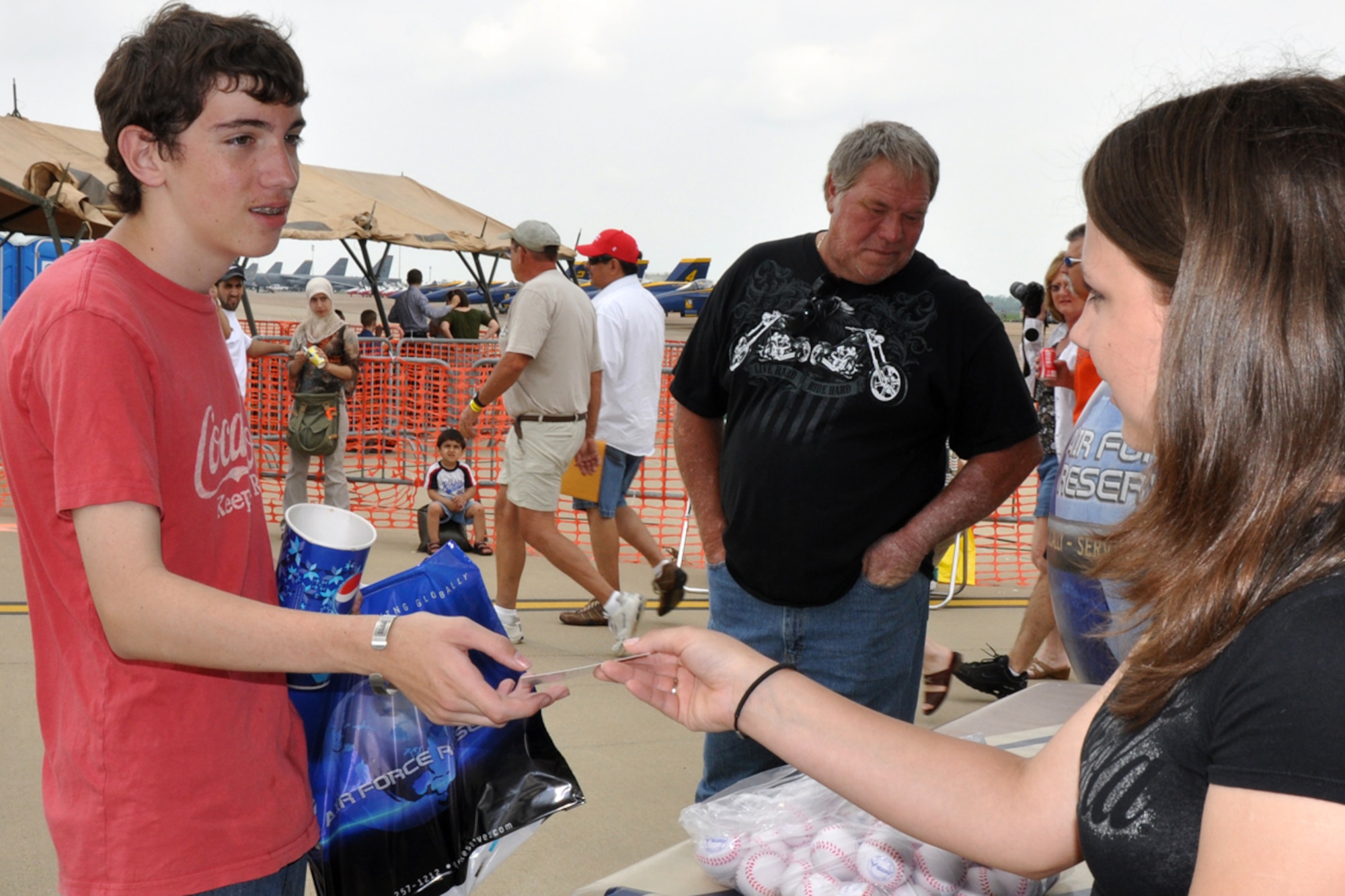 Jacob Hamiter turns in a lead recruiter form to Sylina Brown at the Defenders of Liberty Air Show 2009, at Barksdale Air Force Base, La., May 9. Sylina is a student volunteer from Benton High School in Benton, La., who supported Reserve Recruiters from the 917th Wing at Barksdale during the airshow. The forms will be used to follow up and contact possible prospects for the Air Force Reserves. (US Air Force photo/Tech. Sgt. Jeff Walston)