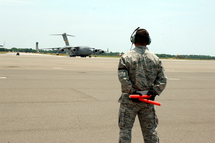 Tech. Sgt. Clint Hutchinson prepares to marshall in a C-17 transporting the Inspector General team on the flightline here May 11. More than 85 inspectors arrived at Charleston AFB to conduct a unit compliance inspection to ensure the base is mission ready. Sergeant Hutchinson is assigned to the 437th Aircraft Maintenance Squadron. (U.S. Air Force photo/Staff Sgt. Marie Cassetty)