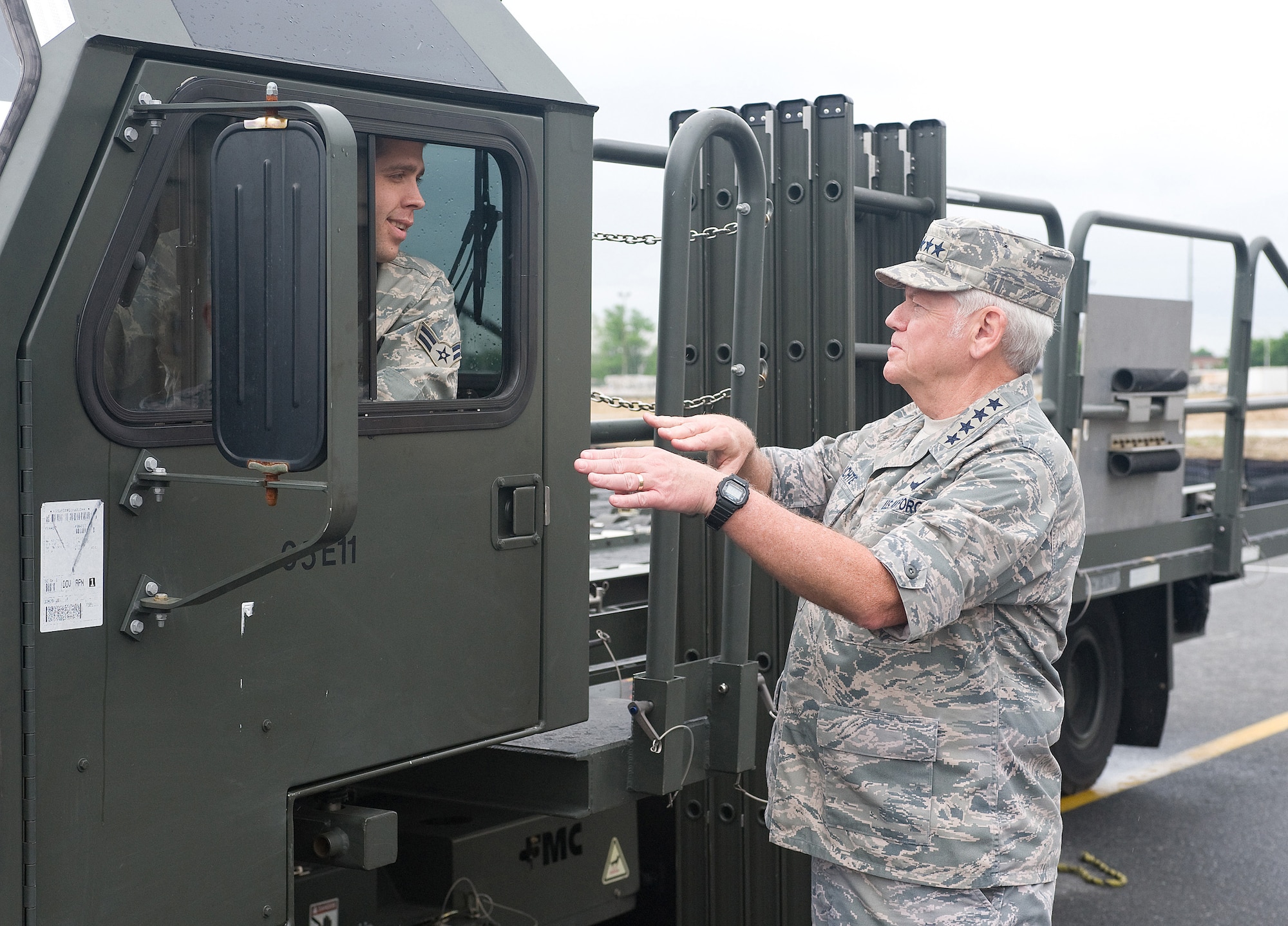 Gen. Arthur J. Lichte, Air Mobility Command commander, speaks with Airman 1st Class Jason W. Bellamy, 436th Aerial Port Squadron ramp services specialist, druing a tour of the Super Port at Dover Air Force Base, Del., May 7. General Lichte, along with other military and industry leaders, toured the Super Port as part of the semi-annual National Defense Transportation Association Military Airlift Committee meeting, which was held at Dover AFB May 7-8. (U.S. Air Force Photo/Tom Randle)