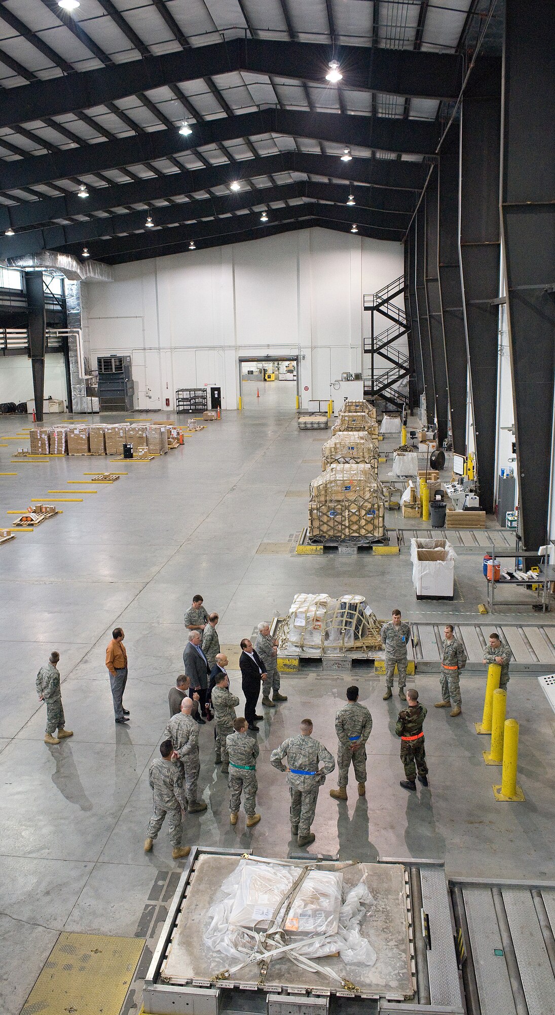 Gen. Arthur J. Lichte, Air Mobility Command commander, receives a tour of the Super Port at Dover Air Force Base, Del., May 7. General Lichte, along with other military and industry leaders, toured the Super Port as part of the semi-annual National Defense Transportation Association Military Airlift Committee meeting, which was held at Dover AFB May 7-8. (U.S. Air Force Photo/Tom Randle)