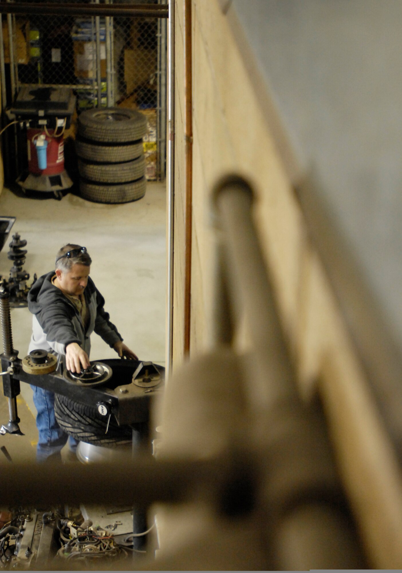 ELMENDORF AIR FORCE BASE, Alaska -- Chris Klisaris is in the auto shop to change his tires taking off his winter tires and is putting on a set of tires for summer, May 8 in the "do it yourself" portion of the shop.(U.S. Air Force photo/Airman 1st Class Christopher Gross)