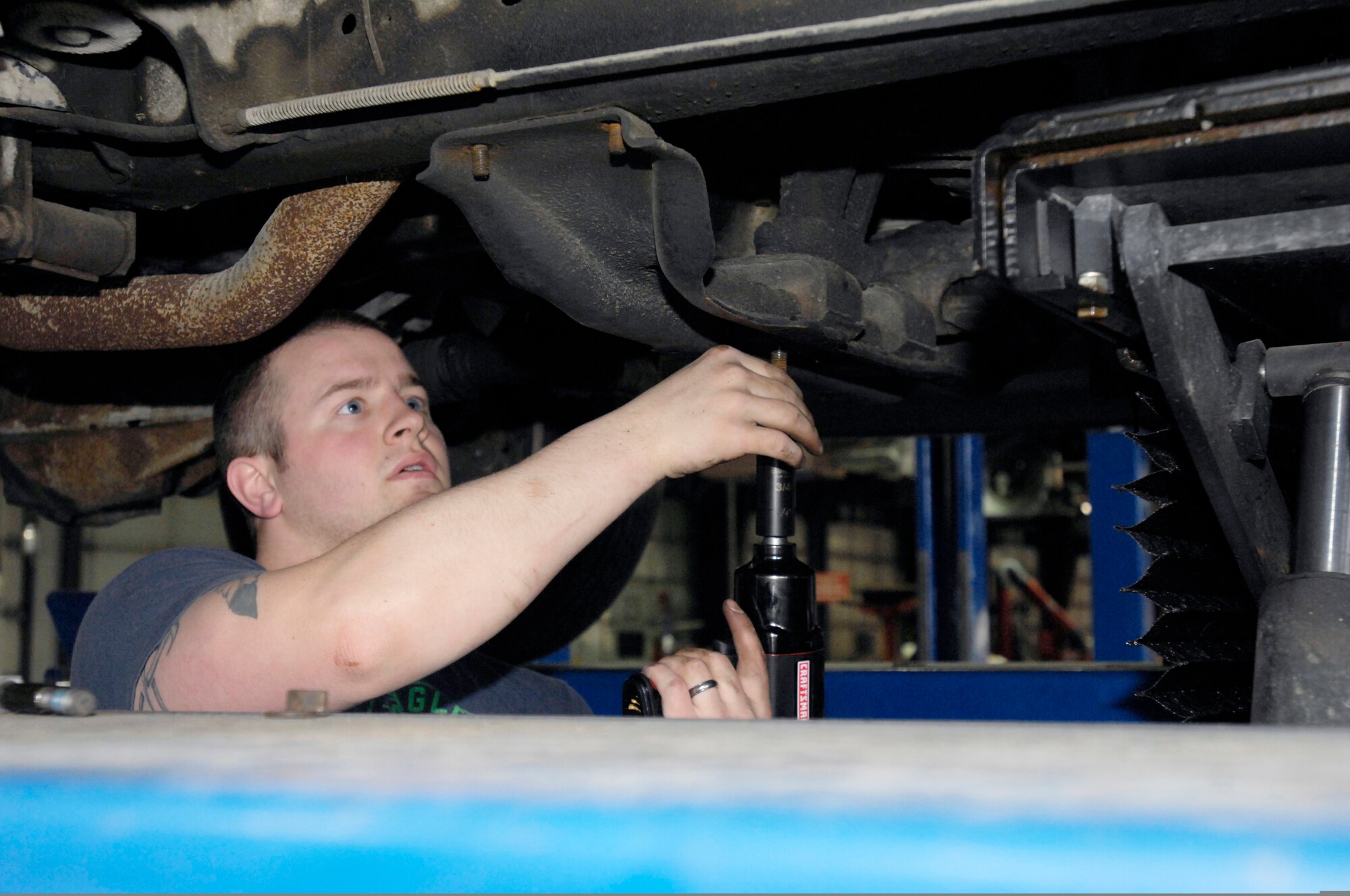 ELMENDORF AIR FORCE BASE, Alaska -- Robert Miller works on removing his flex plate from his truck, May 8 at the auto shop during "do it yourself" hours. Miller is from the 381st Intelligence Squadron.(U.S. Air Force photo/Airman 1st Class Christopher Gross)