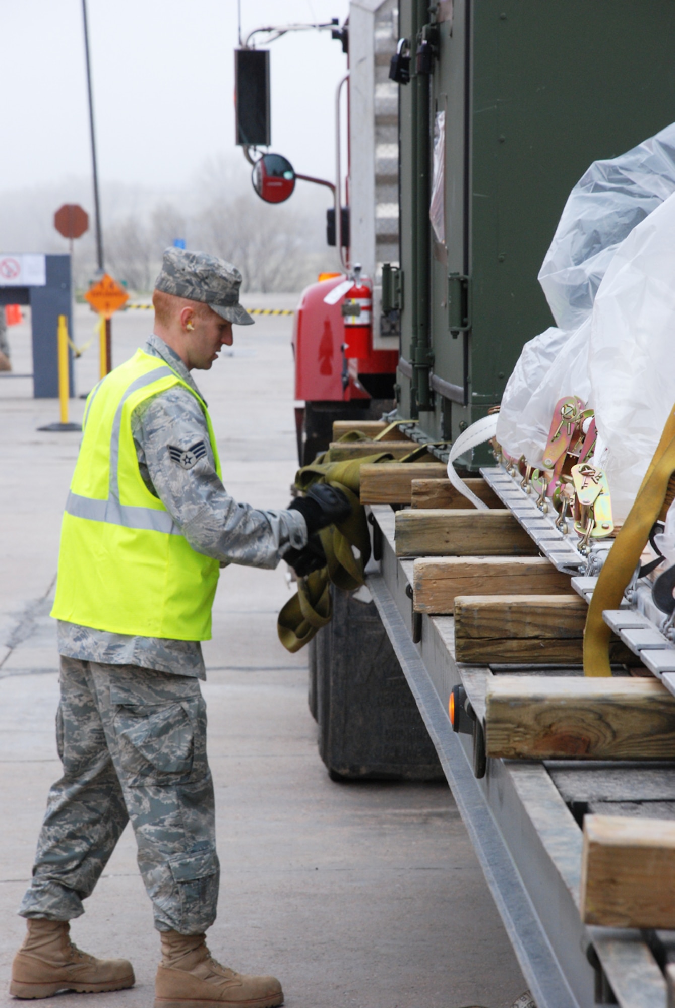 Senior Airman Andy Kruczyk, 90th Civil Engineer Squadron, undoes the straps keeping the cargo in place on the truck April 30 at Bldg. 1284 during the Phase I exercise. The 90th CES Airmen practiced packing and loading cargo and the 90th LRS Airmen practiced unloading and processing cargo during the exercise (U.S. Air Force Photos/Staff Sgt. Chad Thompson).