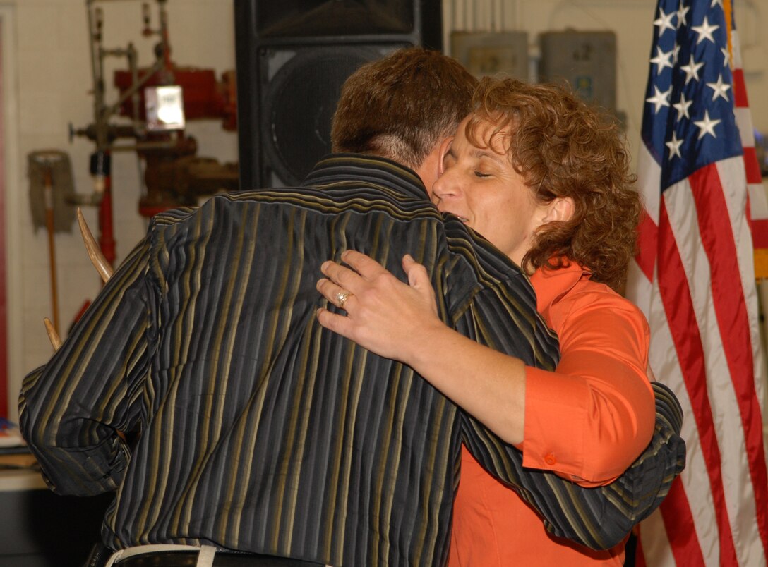 VANDENBERG AIR FORCE BASE, Calif. --  Col. David Buck, the 30th Space Wing commander, gives a farewell hug to Chief Master Sgt. Cari Kent at her going-away dinner here May 8. Chief Kent will take the 341st Missile Wing command chief position at Malmstrom AFB, Mont., after serving two years as the 30th Space Wing command chief here. (U.S. Air Force photo/Airman 1st Class Antoinette Lyons)