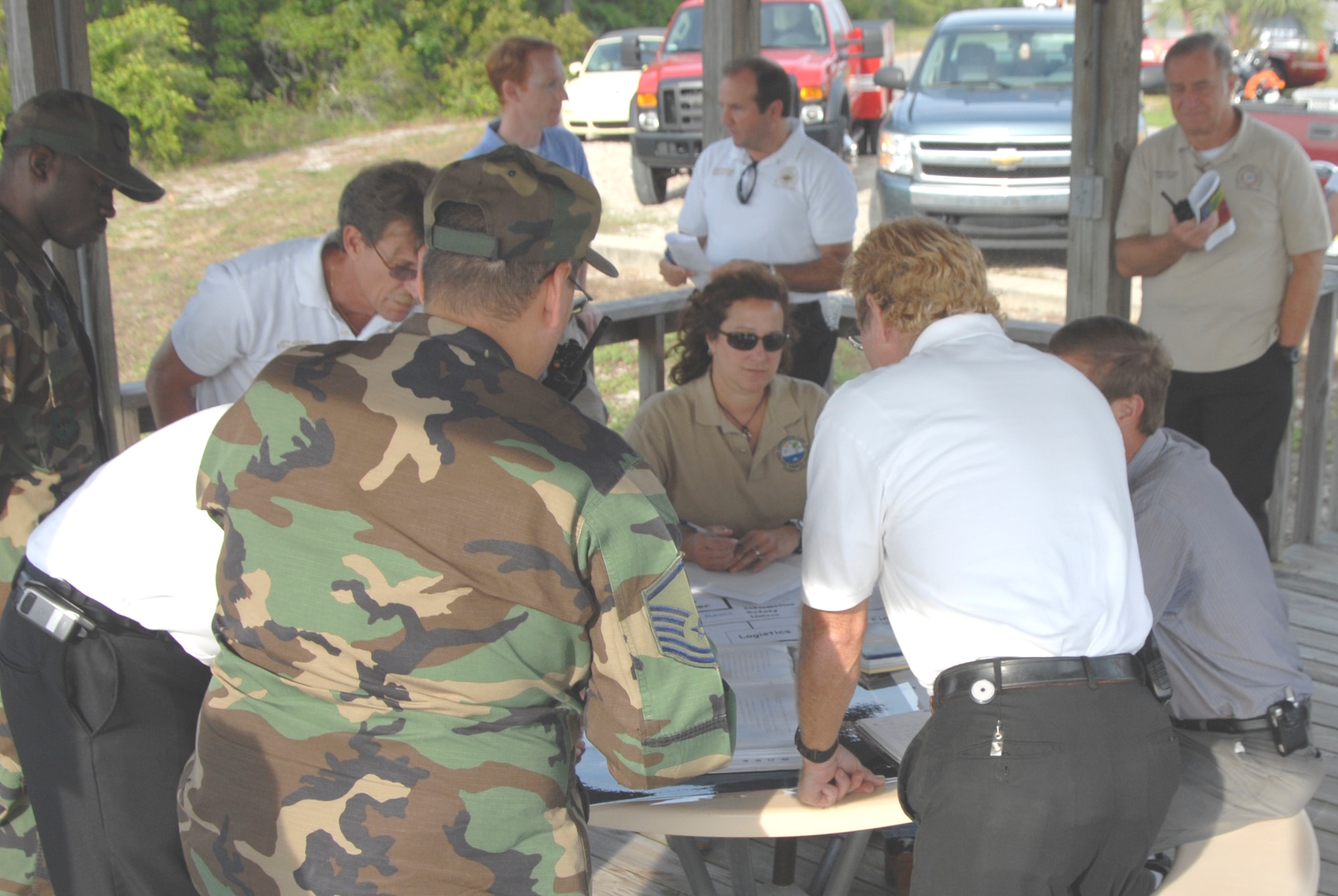 Members of the coordination group for an exercise involving a simulated worst-case oil discharge accident confer about details of the exercise operations May 12 at Tyndall Air Force Base, Fla. Those who took part represented the 325th Civil Engineer Squadron, the Tyndall Fire Department, fuels, Del-Jen, Inc., legal, public affairs, safety and Southern Waste Services, Inc. (U.S. Air Force photo/Robin Walters)