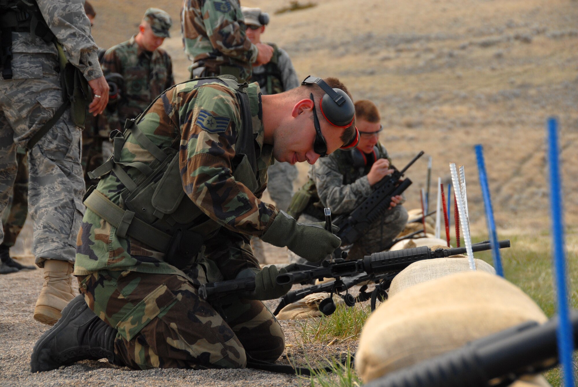 A member of the 185th Air Refueling Wing, Security Forces from Sioux City, Iowa, makes sight adjustments at Fort Harrison, Montana, on 11 May, 2009.  (U.S. Air Force photo by TSgt. Brian Cox)