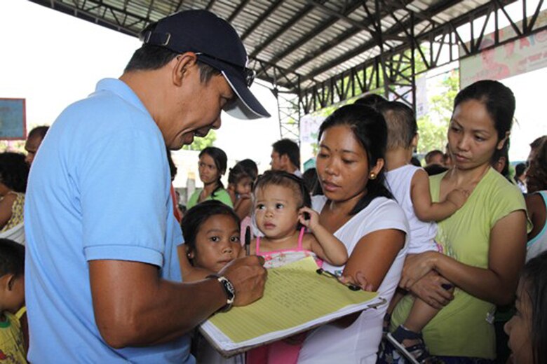 A medic helps Filipino patients register before they are seen by civilian and military medical professionals from the United States, Japan, Australia, Indonesia and Papua-New Guinea May 4 at Sapang Bato, Philippines. The medics are in the Philippines to provide much-needed medical care during the 2009 Association of Southeast Asian Nations Regional Forum Voluntary Demonstration of Response on Disaster Relief. (Courtesy photo) 