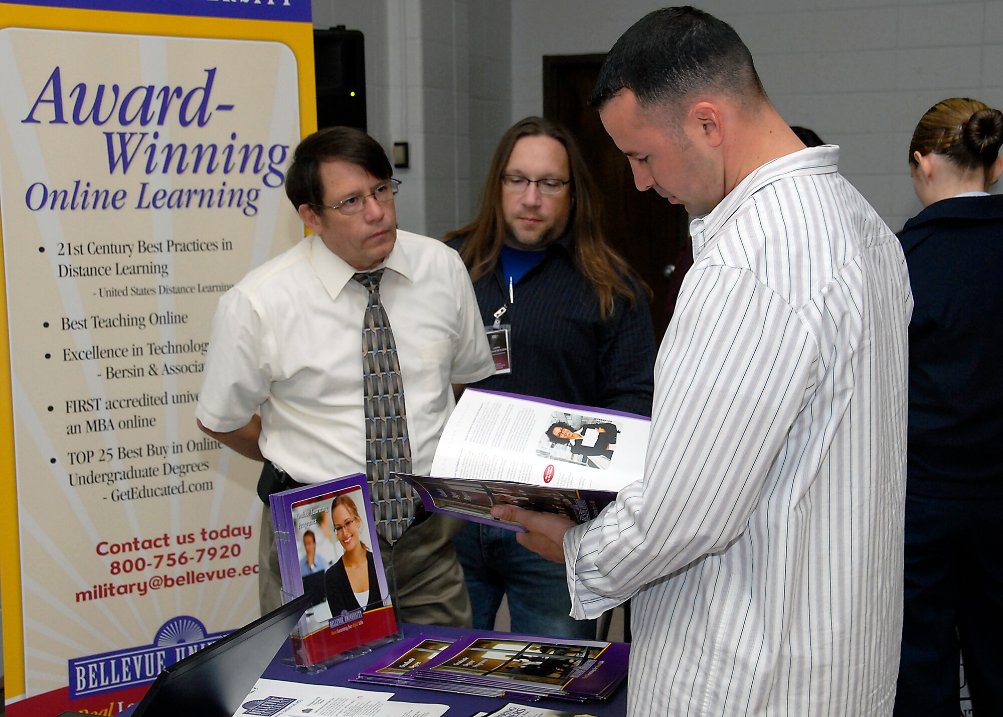 Mr. Roy Crouch, strategic account manager for Bellevue University, shares information about the school with Team Sheppard at the Education Fair May 11. The Education Fair brought various schools to Sheppard to share education opportunities. (U.S. Air Force photo/Mike Litteken)
