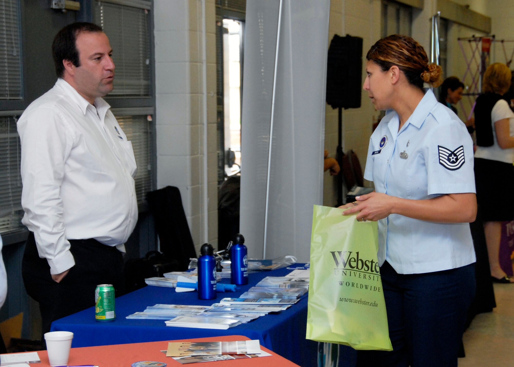 Tom Finaly, vice President of Administration of TUI University, shares informormation about the school with a servicemember at the Education Fair May 11. The Education Fair brought various schools to Sheppard to share education opportunities. (U.S. Air Force photo/Mike Litteken)