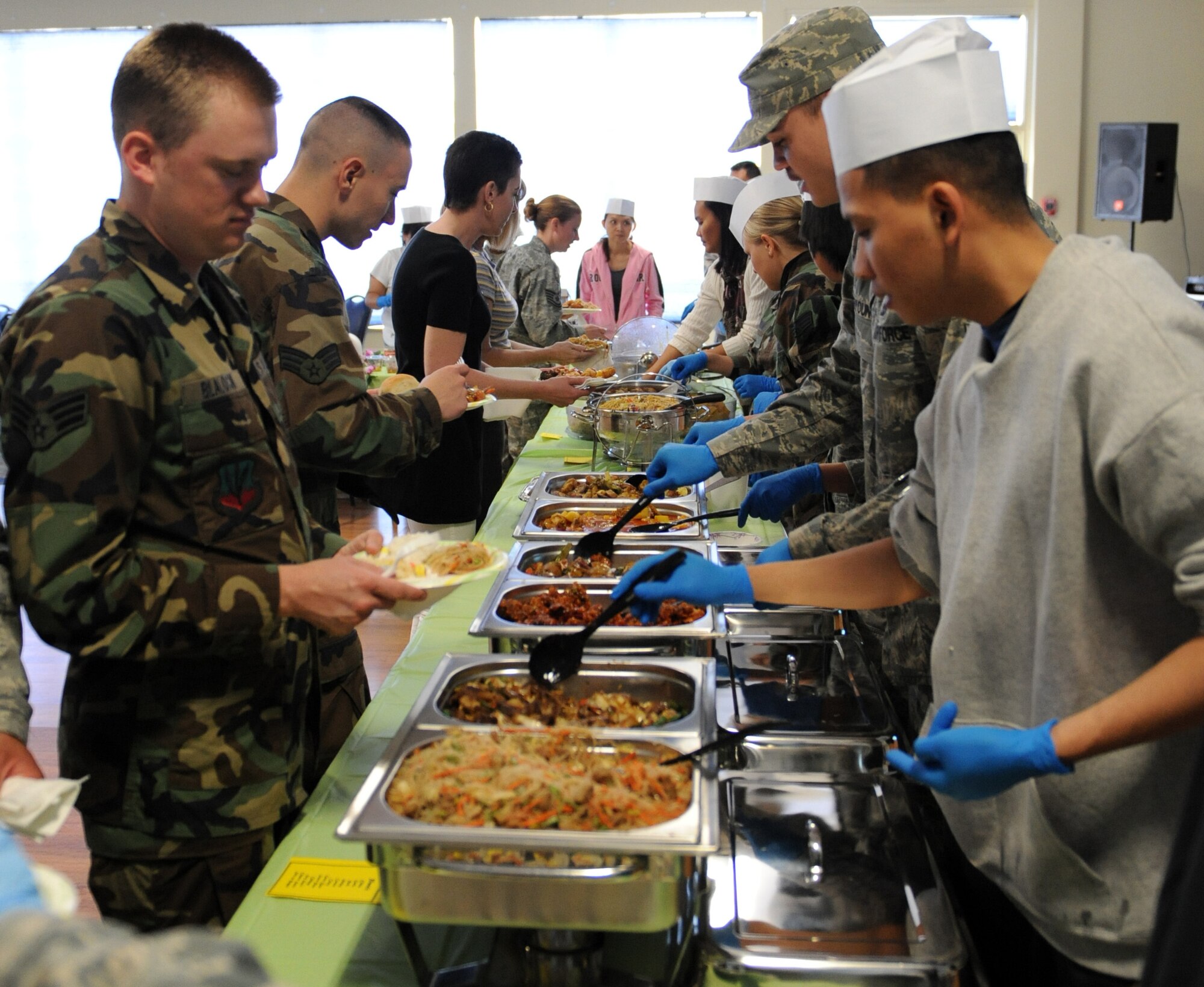 MOUNTAIN HOME AIR FORCE BASE, Idaho - Airmen wait in line to be served dishes from the Asian Pacific American Heritage Committee’s taste fest May 6. Each May, the base joins other installations and organizations across the nation to celebrate Asian-Pacific heritage and honor the contributions these Americans made throughout U.S. history. (U.S. Air Force photo\Airman 1st Class Debbie Lockhart)