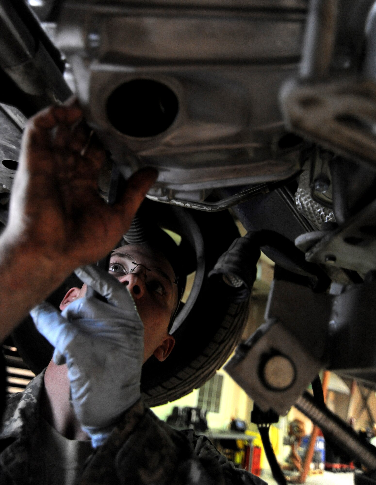 Senior Airman Adam Owens lines-up the fly wheel on a Pontiac GTO with the torque converter of a new transmission April 26 at an air base in Southwest Asia. The GTO is used as a chase car to help guide U-2 pilots during takeoffs and landings. Airman Owens is a 380th Expeditionary Logistics Readiness Squadron, vehicle maintainer deployed from the 174th Air National Guard Base at  Hancock Field, N.Y. He is from Binghamton, N.Y. (U.S. Air Force photo/Senior Airman Brian J. Ellis)