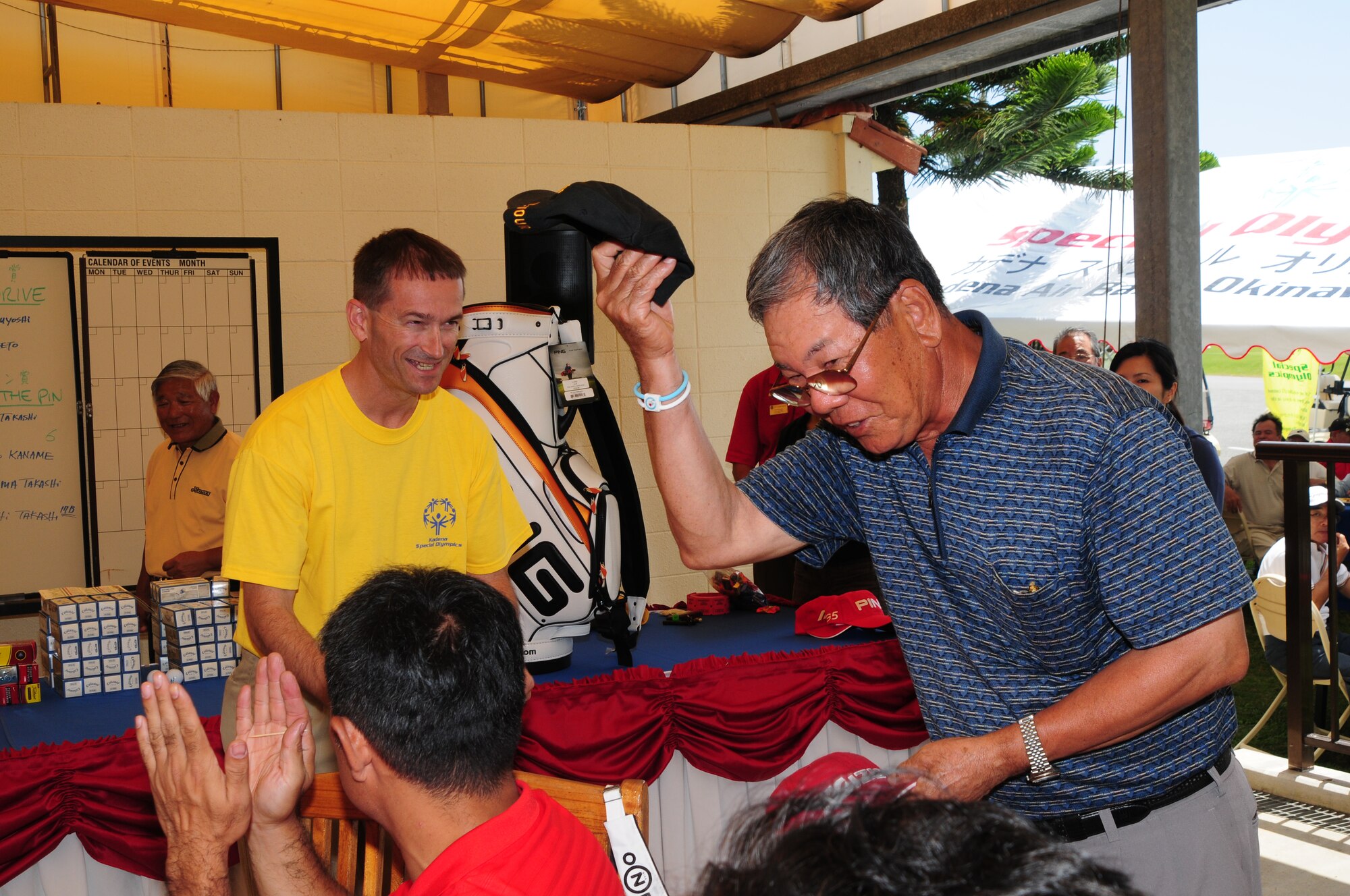 A participant in the Jimmy Schwartz Golf Tournament collects his raffle prize at the 9th Hole eatery, Kadena Air Base, Japan, May 5, 2009. The tournament is held annually to raise money for the Kadena Special Olympics. (U.S. Air Force photo/Staff Sergeant Lakisha A. Croley)