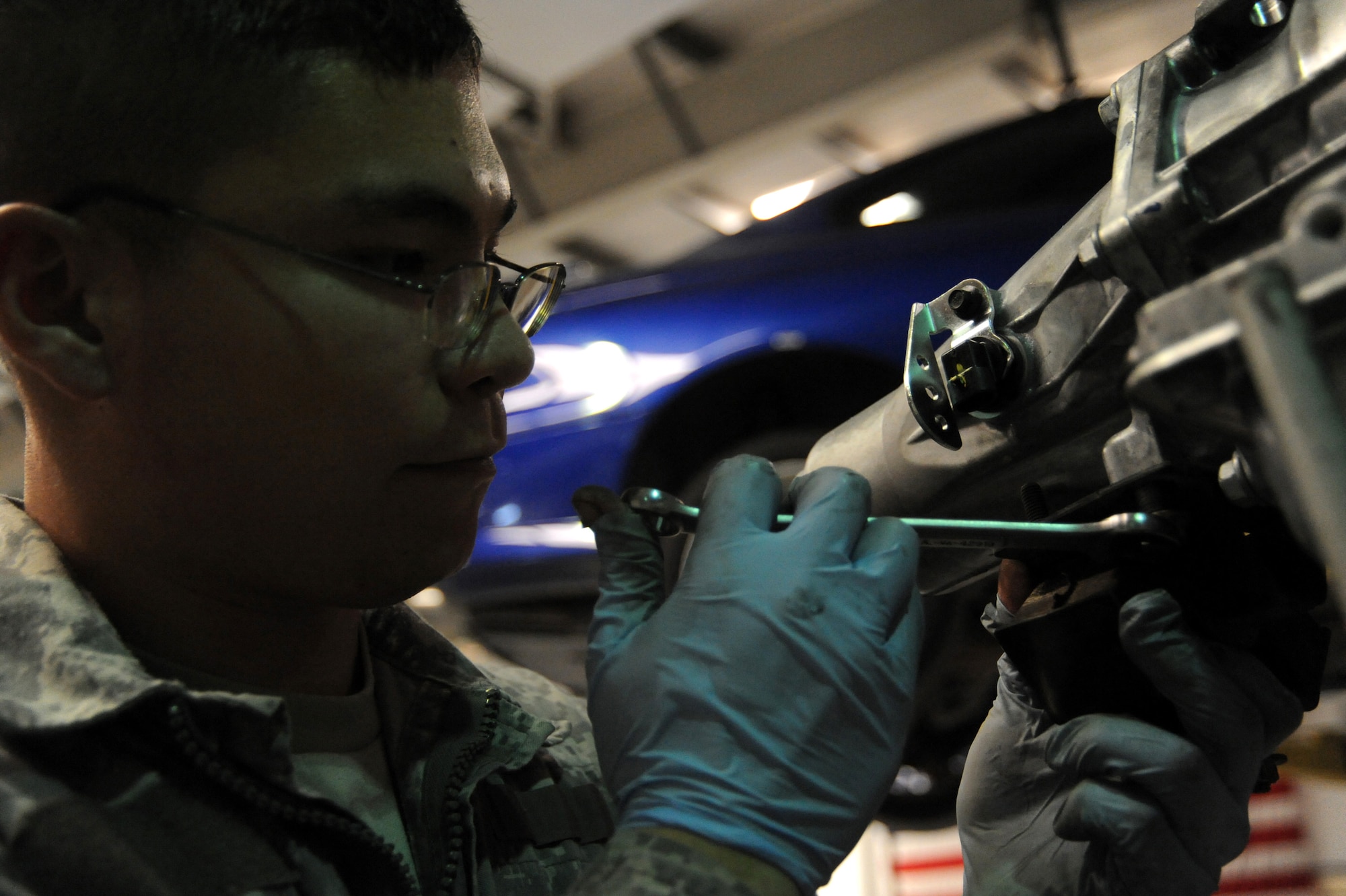 Senior Airman Michael Jakubec tightens a bolt for a mounting bracket on a new transmission for a Pontiac GTO April 26 at an air base in Southwest Asia. The bracket will mount to the body of the vehicle for rear support. The GTO is used as a chase car to help guide U-2 pilots during takeoffs and landings. Airman Jakubec is a 380th Expeditionary Logistics Readiness Squadron vehicle maintainer deployed from Kadena Air Base, Japan. He is from Spanaway, Wash. (U.S. Air Force photo/Senior Airman Brian J. Ellis)