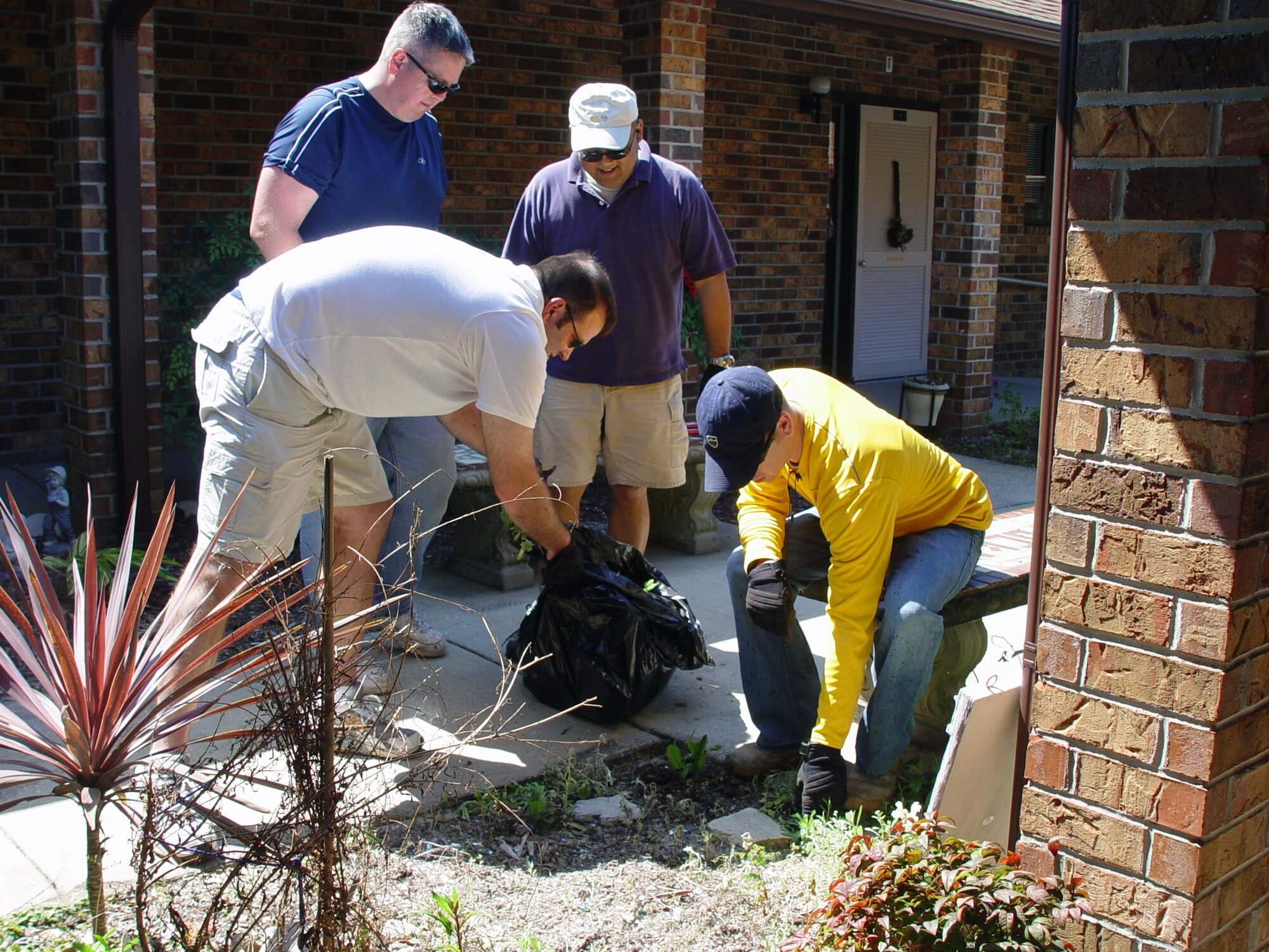 Members of the 505th Command and Control Wing at Hurlburt Field help clean up the grounds at the Air Force Enlisted Village during a volunteer project recently. Team 505th participates in several organized outreach programs for the local community, including Adopt-A-County Road and Meals on Wheels.