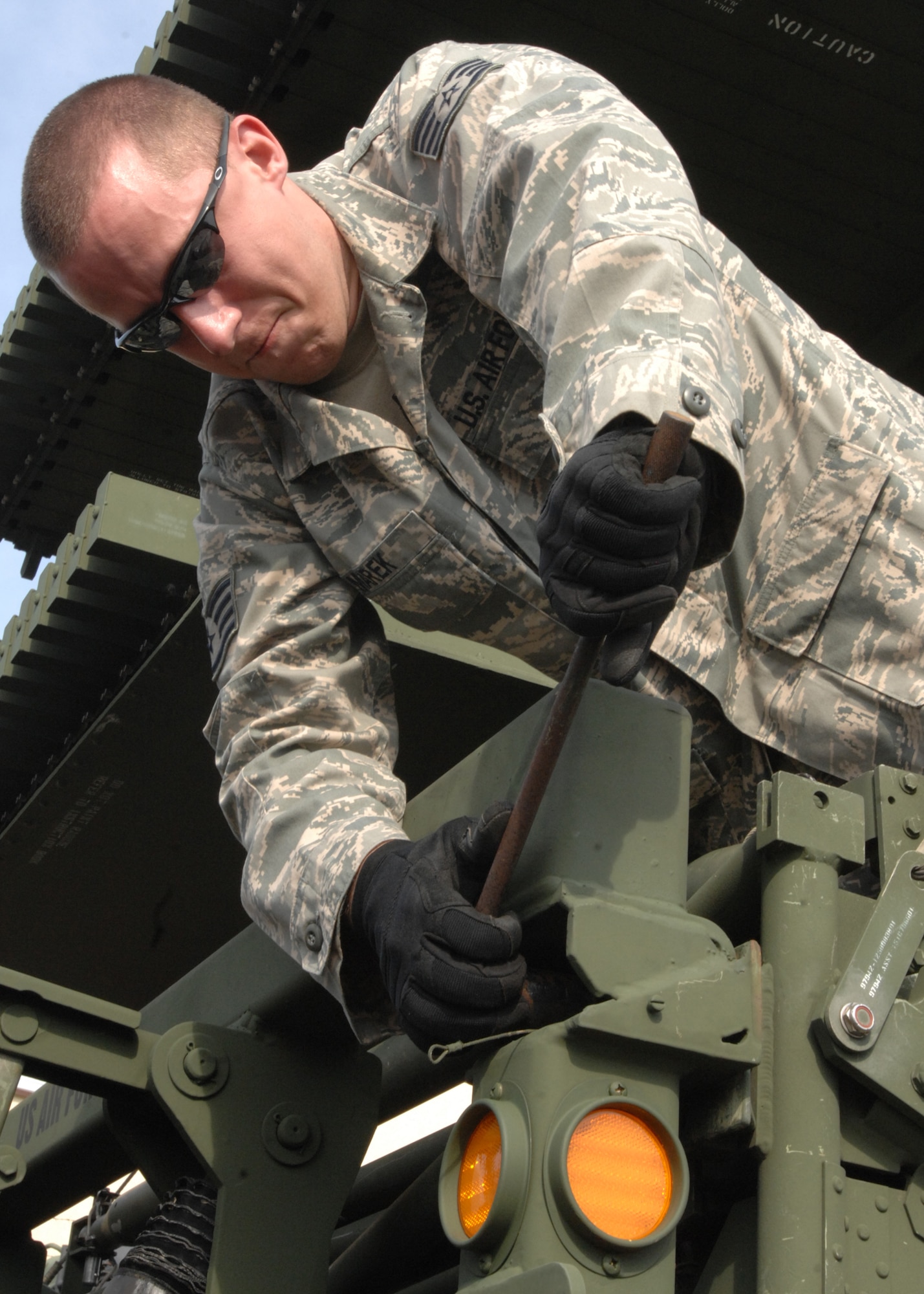 SPANGDAHLEM AIR BASE, Germany – Staff Sgt. Christopher Marek, 606th Air Control Squadron, attaches an M-832 mobilizer to an AN/TPS-75 Radar System antenna. The M-832 mobilizer is designed for handling and transport of tactical shelters and portable military radar platforms. (U.S. Air Force photo by Senior Airman Jenifer Calhoun)