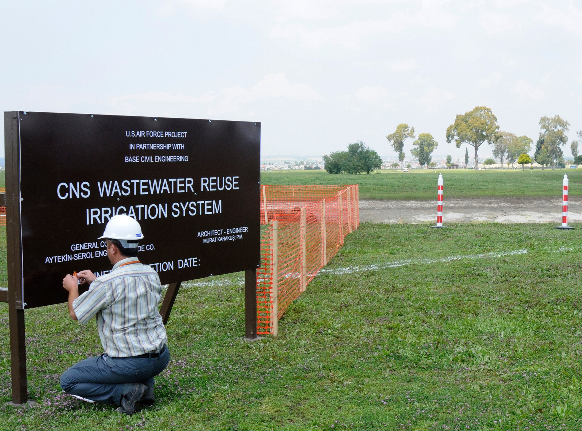 A Turkish contractor with Aytekin Serol, places the final touches on a sign introducing the “construct waste water reuse irrigation system” project at Incirlik’s Hodja Lake Golf Course May 8, 2009 at Incirlik Air Base, Turkey.  The purpose of the project is the reuse of treated water for the golf course’s irrigation, to replace the currently used potable water, which is supplied from on and off-base wells. This will save energy and money, reducing the potable water demand. The new irrigation system will cover the fairways, tees, greens, internal and external rough areas and driving range.  (U.S. Air Force photo/Airman 1st Class Amber Russell)