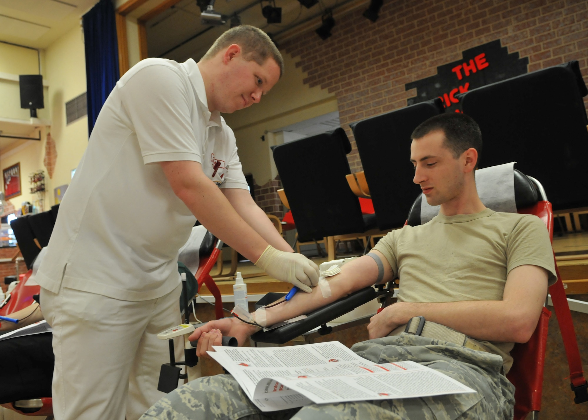 SPANGDAHLEM AIR BASE, Germany – Airman 1st Class Bradley Kasch, American Forces Network Spangdahlem, waits to donate blood as Andreas Niebuhr, German Red Cross paramedic, prepares him for the procedure May 7, 2009. The German Red Cross was at the Brick House so qualified servicemembers, German nationals, Department of Defense employees and dependants could donate blood. (U.S. Air Force photo by Airman 1st Class Nicholas Wilson)