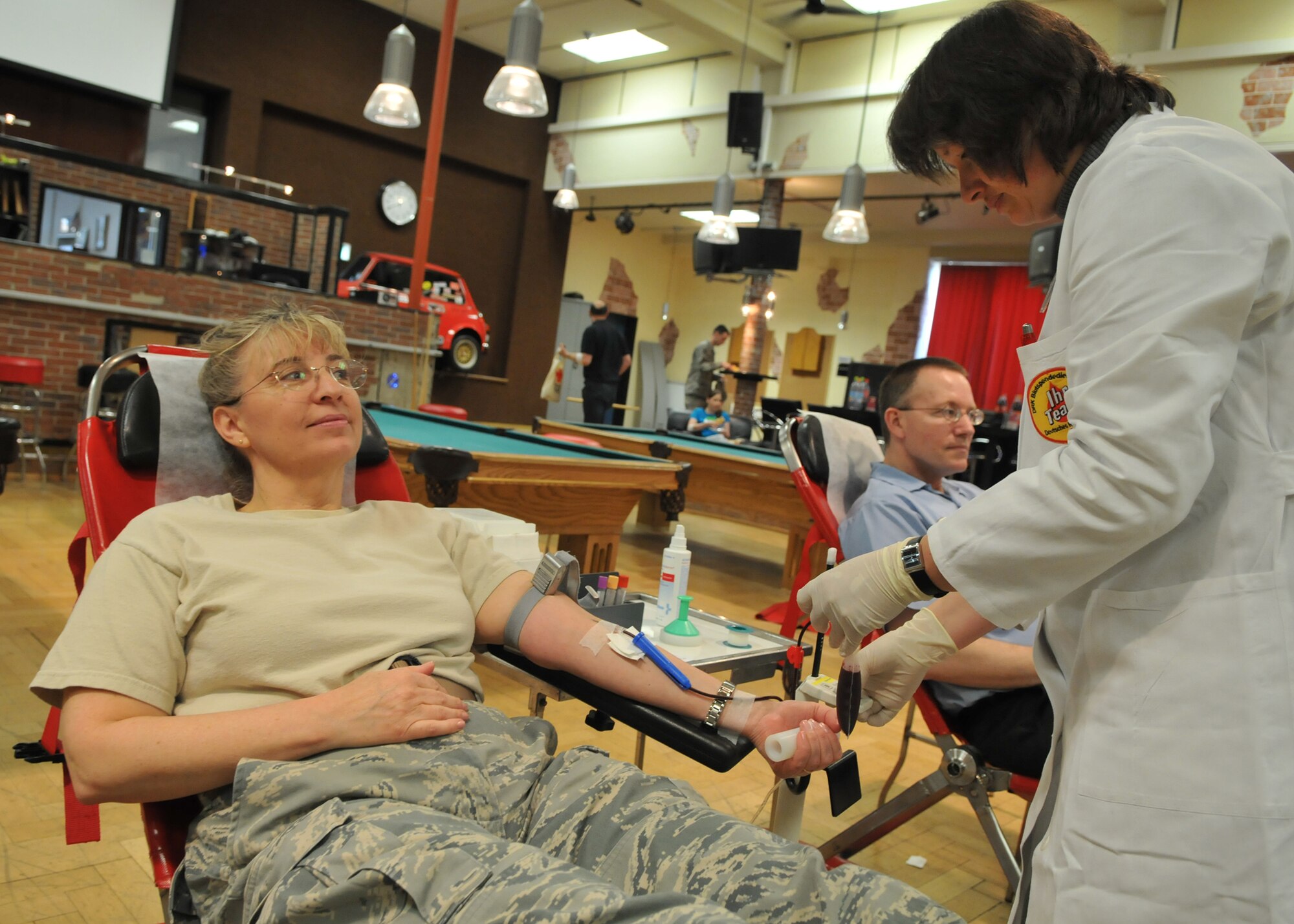 SPANGDAHLEM AIR BASE, Germany – Col. Lorrie Cappellino, 52nd Medical Group command, donates blood as Frau Barzen, German Red Cross paramedic, performs the procedure. Members of the 52nd Fighter Wing, both civilian and military, donated blood at the Brick House May 7, 2009.  (U.S. Air Force photo by Airman 1st Class Nicholas Wilson)