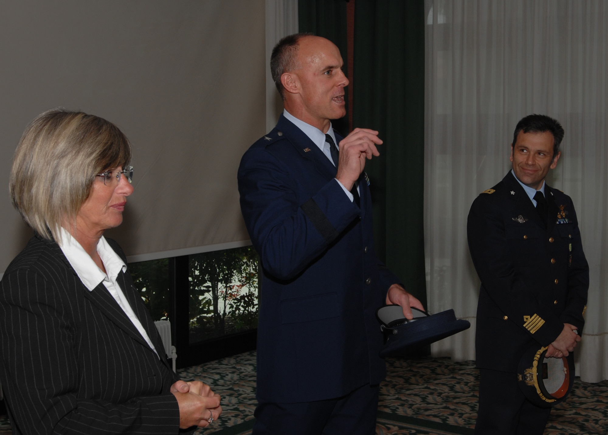 Brig. Gen. Craig Franklin, 31st Fighter Wing commander, uses his Italian language skills to greet the 12 Italian community leaders prior to their induction into the 31st FW Honorary Squadron Commander Program held at the La Bella Vista Club at Aviano Air Base, Italy, May 8, 2009.  Leading up to the ceremony, inductees were met by General Franklin, Col. Filippo Zampella, right, the Pagliano e Gori Airport commander, and their respective unit commanders for a brief social. Luisa Merlo, 31st FW public affairs specialist, left, provided translation support for the commander.  (U.S. Air Force photo/Staff Sgt. Patrick Dixon)