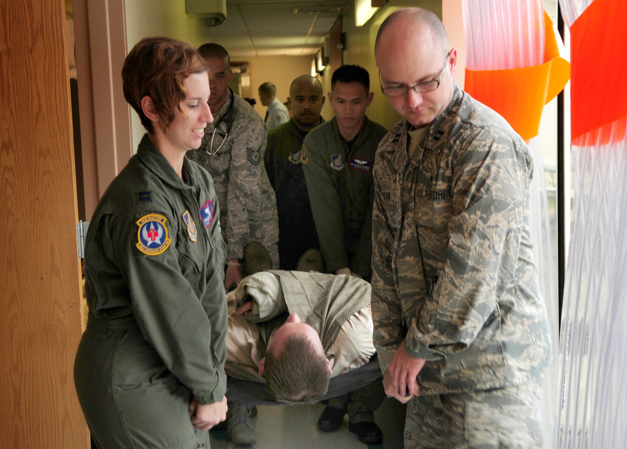 Members of the 18th Medical Group, participate in a self-aid and buddy care simulation, during the Beverly High 09-2 Local Operational  Readiness Excercise May 11. The LORE tests base personnel on their combat readiness for real world emergency/combat events.  (U.S. Air Force photo/Staff Sergeant Lakisha A. Croley )