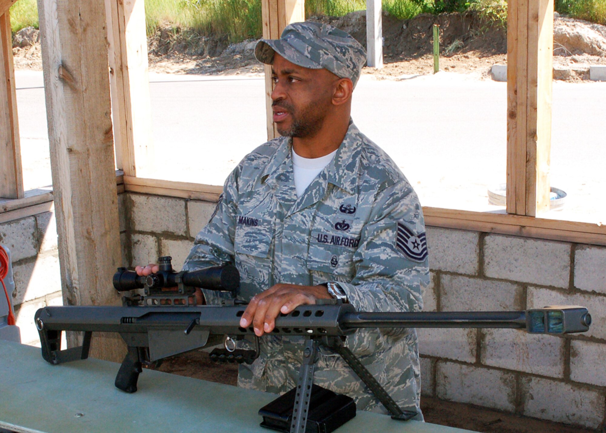 Tech. Sgt. Carl Makins speaks about a Barretta 50-caliber rifle during an Explosive Ordnance Disposal demonstration at Manas Air Base, Kyrgyzstan, May 12. Sergeant Makins is the EOD flight chief assigned to the 376th Civil Engineer Squadron. He is a Reservist deployed from the 315th CES at Charleston Air Force Base, S.C., and is originally from Inman, S.C. (U.S. Air Force photo/Tech. Sgt. Elizabeth Weinberg)    