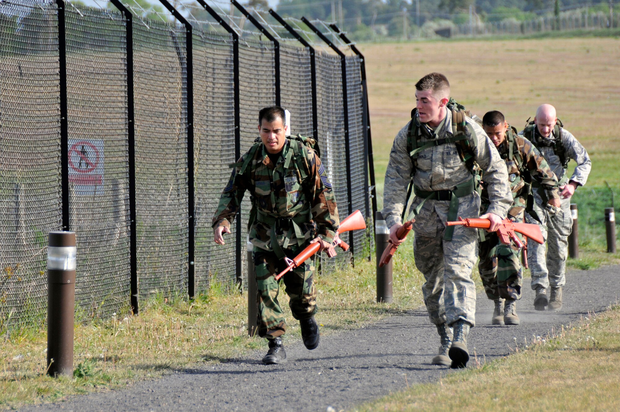 ROYAL AIR FORCE LAKENHEATH, England -- Airmen run to the next obstacle during the 2009 National Police Week 5k Ruck March May 11, 2009. The 5K Ruck March is one of many events for the 2009 National Police Week.  (U.S. Air Force photo by Airman 1st Class Perry Aston) 