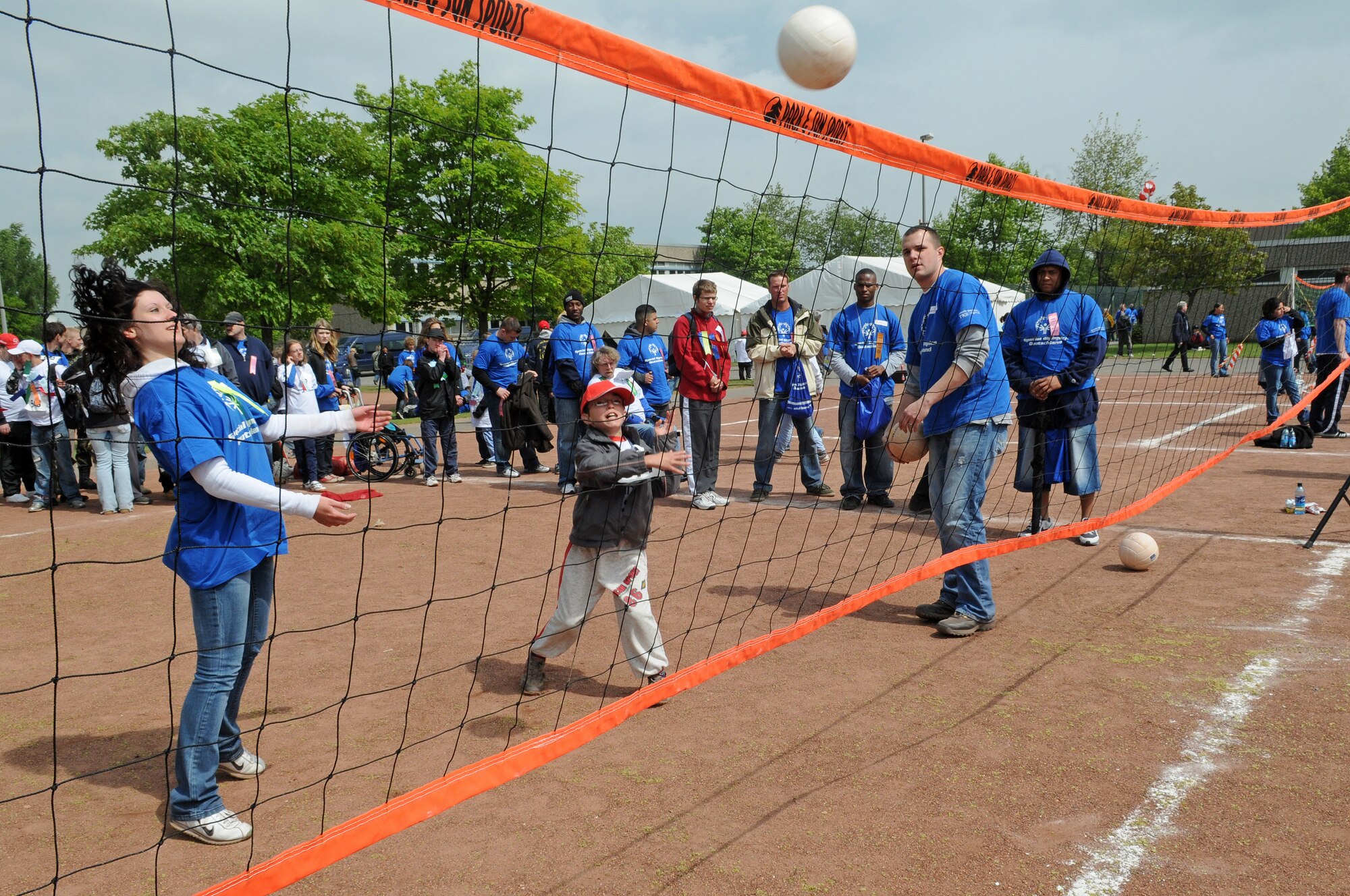 A German local national hits the ball over the net while playing a game of volleyball during the 36th Annual Special Olympics held in Enkenbach-Alsenborn, Germany, May 6, 2009. Special Olympics is an international program of year-round sports training and athletic competition for more than 1.7 million children and adults with disabilities in more than 150 countries including Germany. (U.S. Air Force photo by Airman 1st Class Grovert Fuentes-Contreras)(Released)