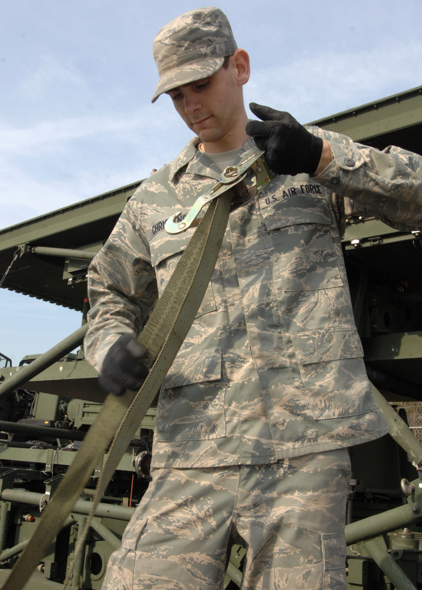 SPANGDAHLEM AIR BASE, Germany – Airman 1st Class Devin Christensen, 606th Air Control Squadron, prepares straps to secure an M-832 mobilizer April 7, 2009, being packed for the unit’s upcoming deployment to Afghanistan. (U.S. Air Force photo by Senior Airman Jenifer Calhoun)