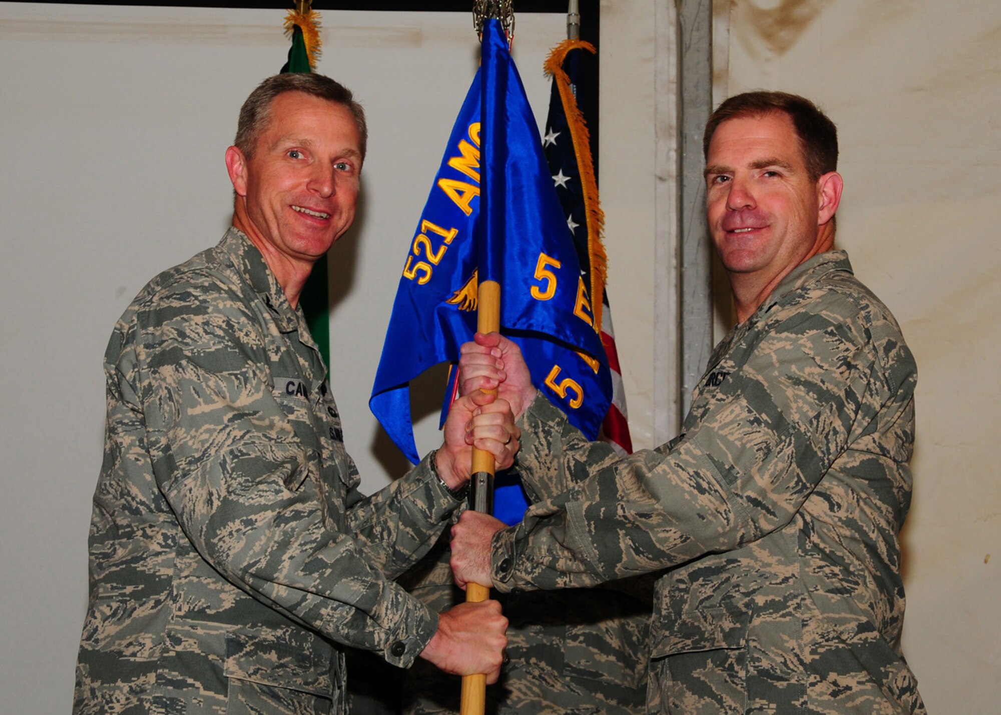 SOUTHWEST ASIA -- Lt. Col. Michael O. Cannon assumes command of the 5th Expeditionary Air Mobility Squadron from Col. Gordon Campbell, 521st Air Mobility Operations Group commander, at an air base in Southwest Asia, May 8. 5 EAMS is the busiest passenger operation in Air Mobility Command, moving almost a million passengers and a quarter million tons of cargo per year. (U.S. Air Force photo/ Senior Airman Courtney Richardson)