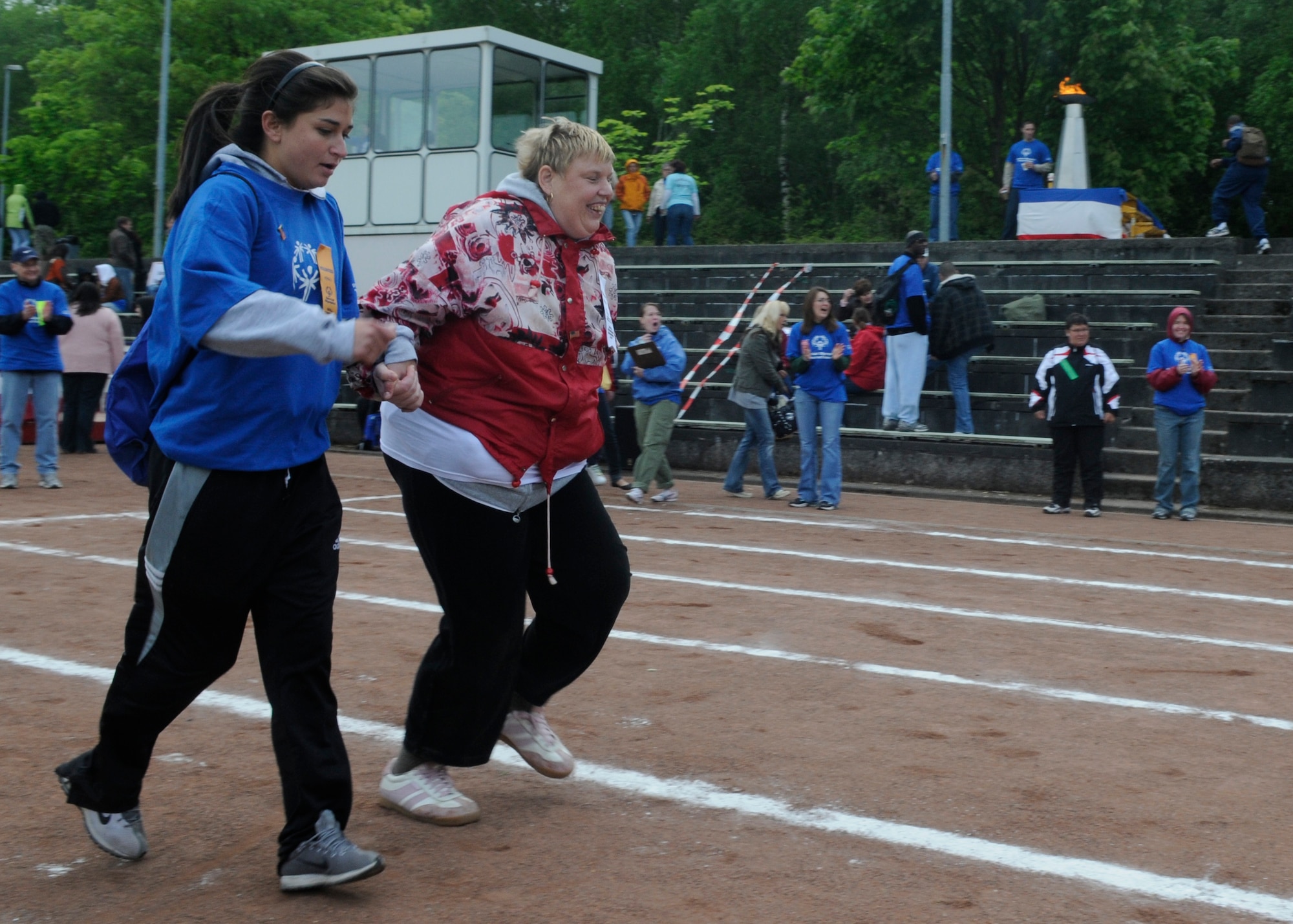 KAISERSLAUTERN, Germany – Airman 1st Class Jillian Trujillo, 726th Air Mobility Squadron, joins her buddy during the 50 meter dash at the U.S. Army Garrison Kaiserslautern Special Olympics Spring Games at the Police Academy in Enkenbach-Alsenborn May 6, 2008. (U.S. Air Force photo by Airman 1st Class Staci Miller)