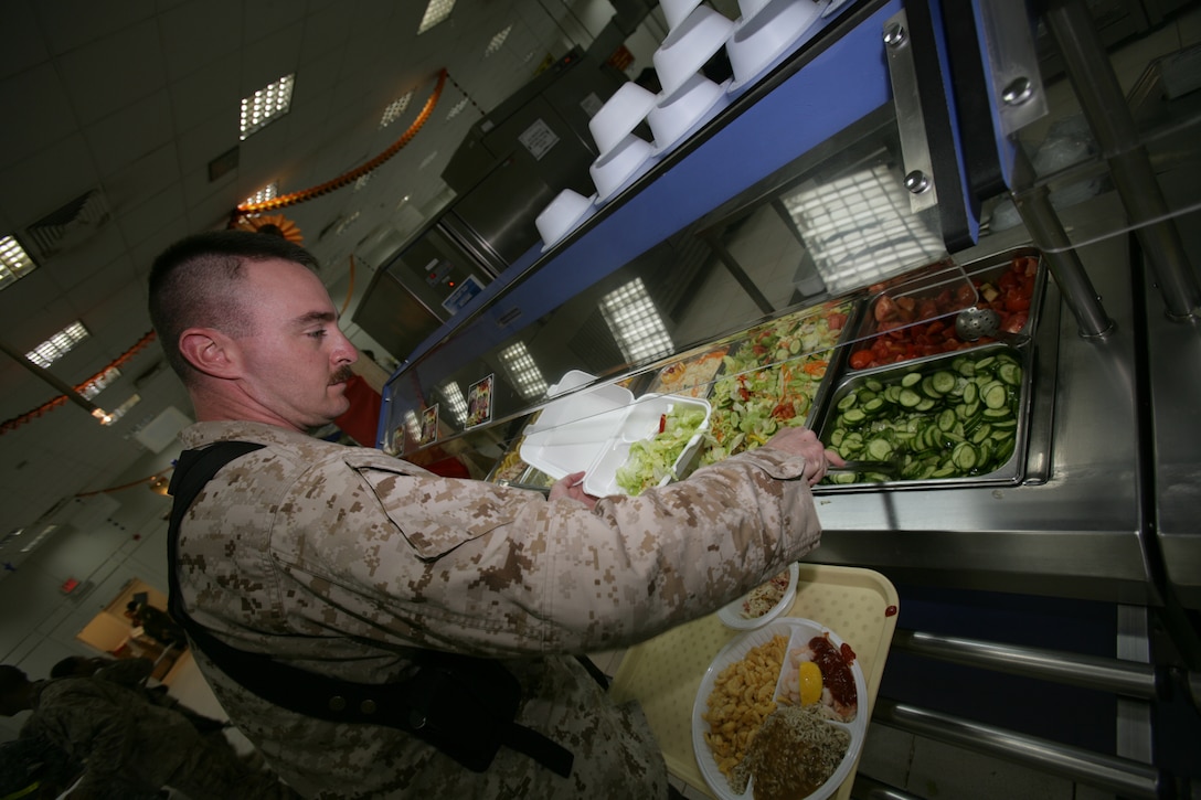 Marine Gunnery Sgt. Daniel Starkey serves himself salad at a dining facility on Al Asad Air Base, Iraq. Defense Supply Center Philadelphia acquires most produce from local markets for troops deployed to Iraq and Afghanistan. Marine Corps photo by Cpl. Jose J. Aguirre