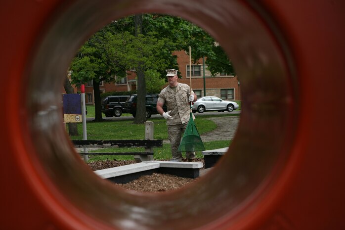 Staff Sgt. Kevin T. Crown, 23, Company Gunnery Sergeant for Headquarters and Service Company from the Chicago-based 2nd Battalion, 24th Marine Regiment, rakes up leaves at Levin Park, Chicago. Marines from various units helped to clean the park. The event was one of many activites being conducted by Marines for Marine Week Chicago.
