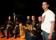 Francisco Flores, an 18-year-old senior at Roberto Clemente High School, poses with Marines from the Twentynine Palms Marine Band during a brass quintet performance at the high school here today.  Flores asked for more information about opportunities in the Marine Corps as a musician after the performance from the Twentynine Palms, Calif.-based band. The performance was one of several throughout the Chicagoland area as part of the inaugural Marine Week Chicago, which runs through Sunday. The weeklong event provides an opportunity for Chicago citizens to meet the men and women of the Marine Corps and learn about its history, traditions and value to the nation.