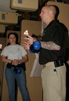 Sgt. James White, combat marksmanship instructor, from Weapons Training Battallion in Quantico, Va., explains to Chicago police officers how Marines properly engage targets during a tactical and pistol marksmanship training exercise at the Chicago Police Education and Training Academy.