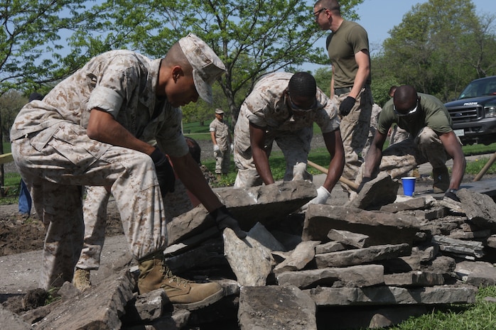 Marines with 1st Marine Division move slabs of concrete from a pathway at Riis Park in Chicago May 12, 2009. Marines are cleaning up parks as well as taking part in other community services and efforts as part of Marine Week being held in Chicago. (U.S. Marine Corps photo by Cpl. Seth Maggard/Released)